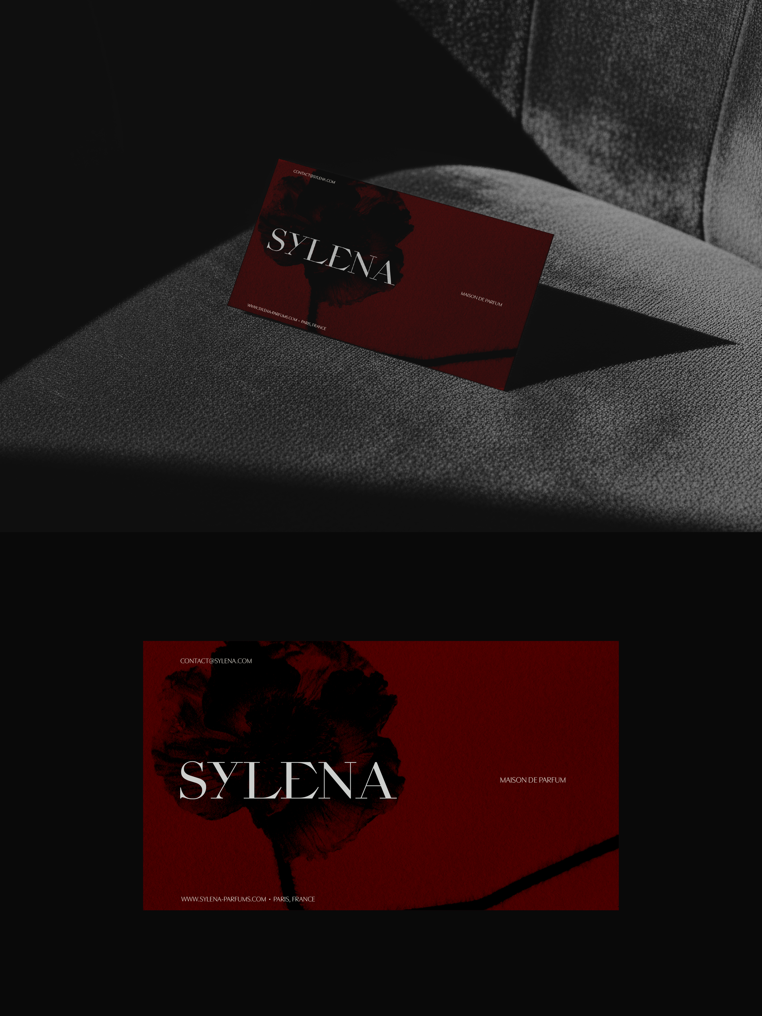 Two deep red Sylena business cards, one resting on a grey velvet chair