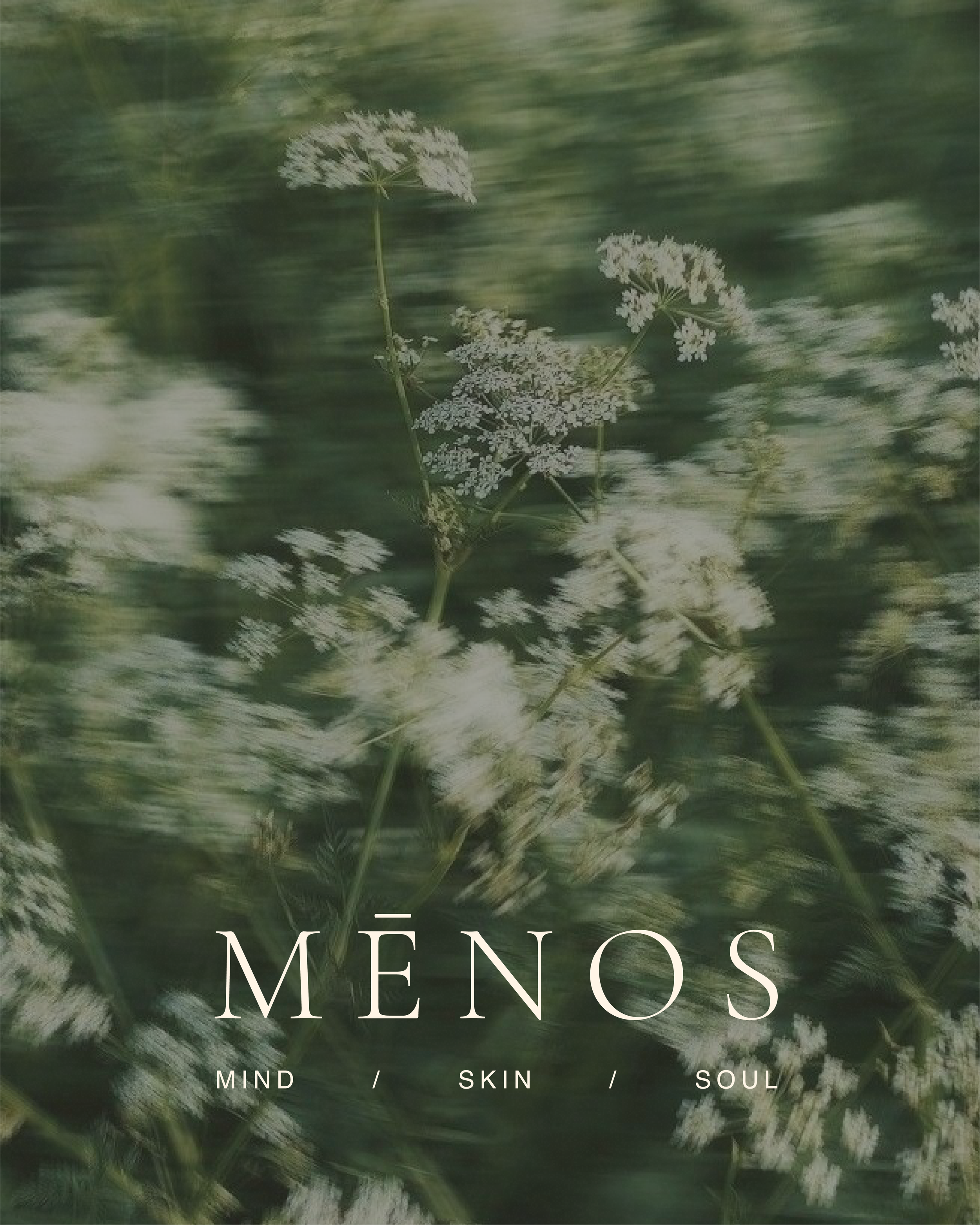 MĒNOS logo and Mind, Skin, Soul tagline over a field of white wildflowers