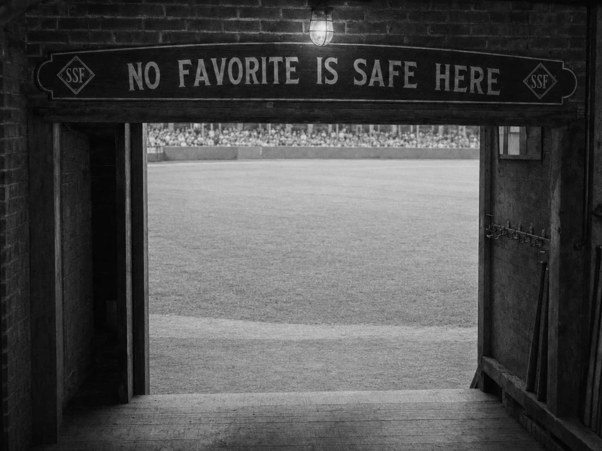 The painted “No Favorite Is Safe Here” sign hangs above the shared players’ passage inside The Hatbox.