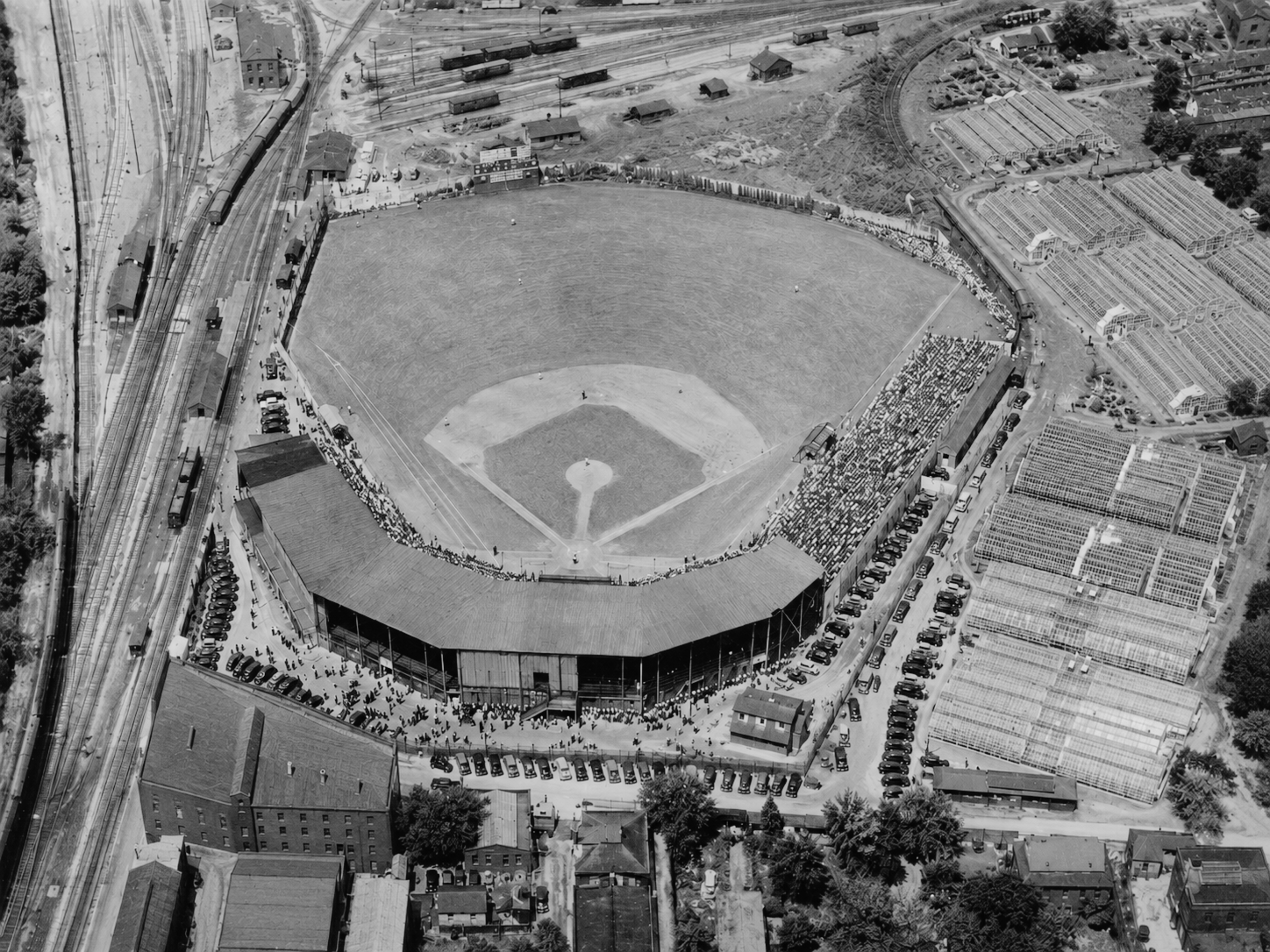 Aerial view of West End Park during a Davenport Deadheaders game, surrounded by freight yards and industrial buildings.