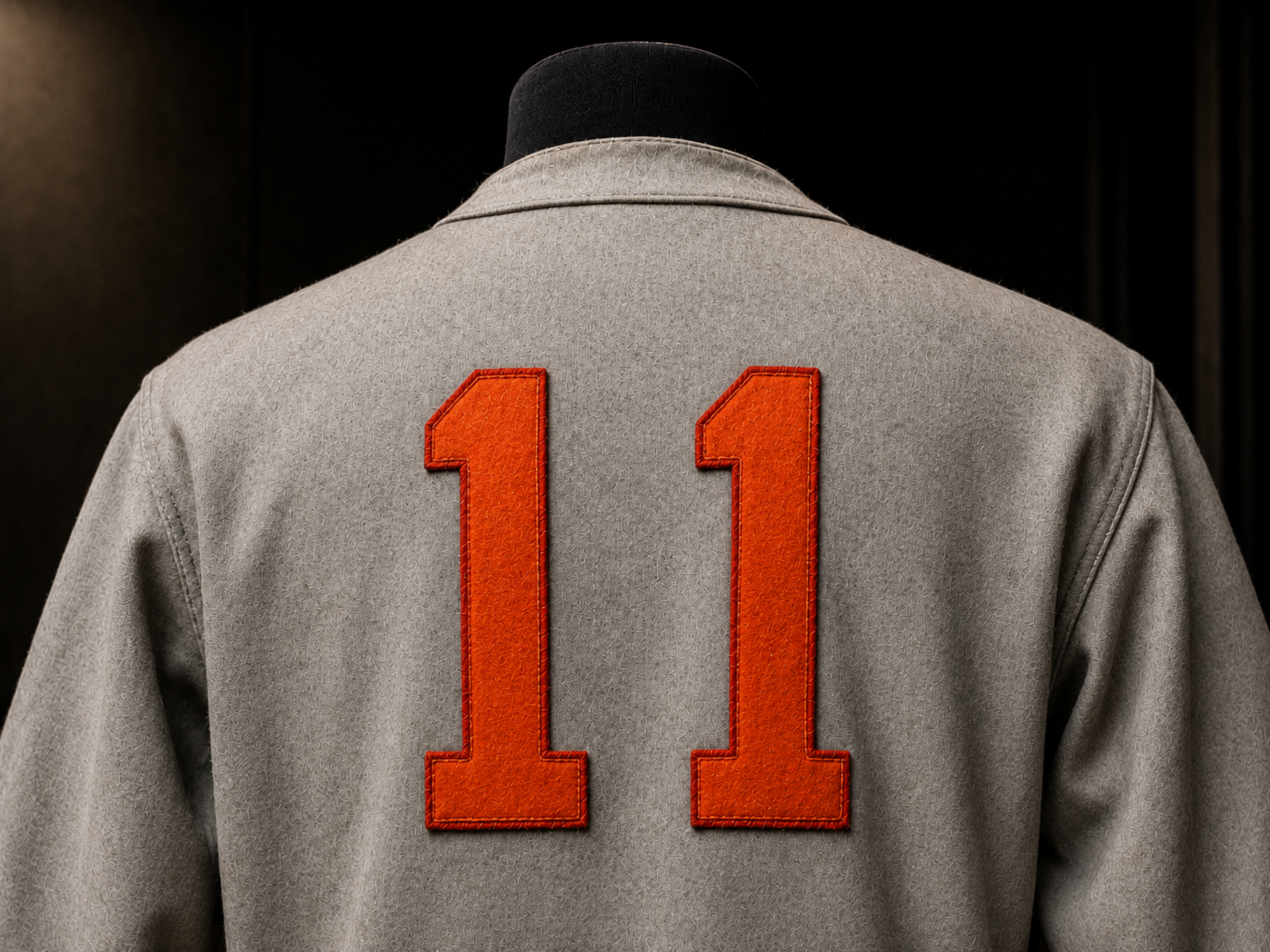 Back number on gray Albany Orange Wonders travel jersey.