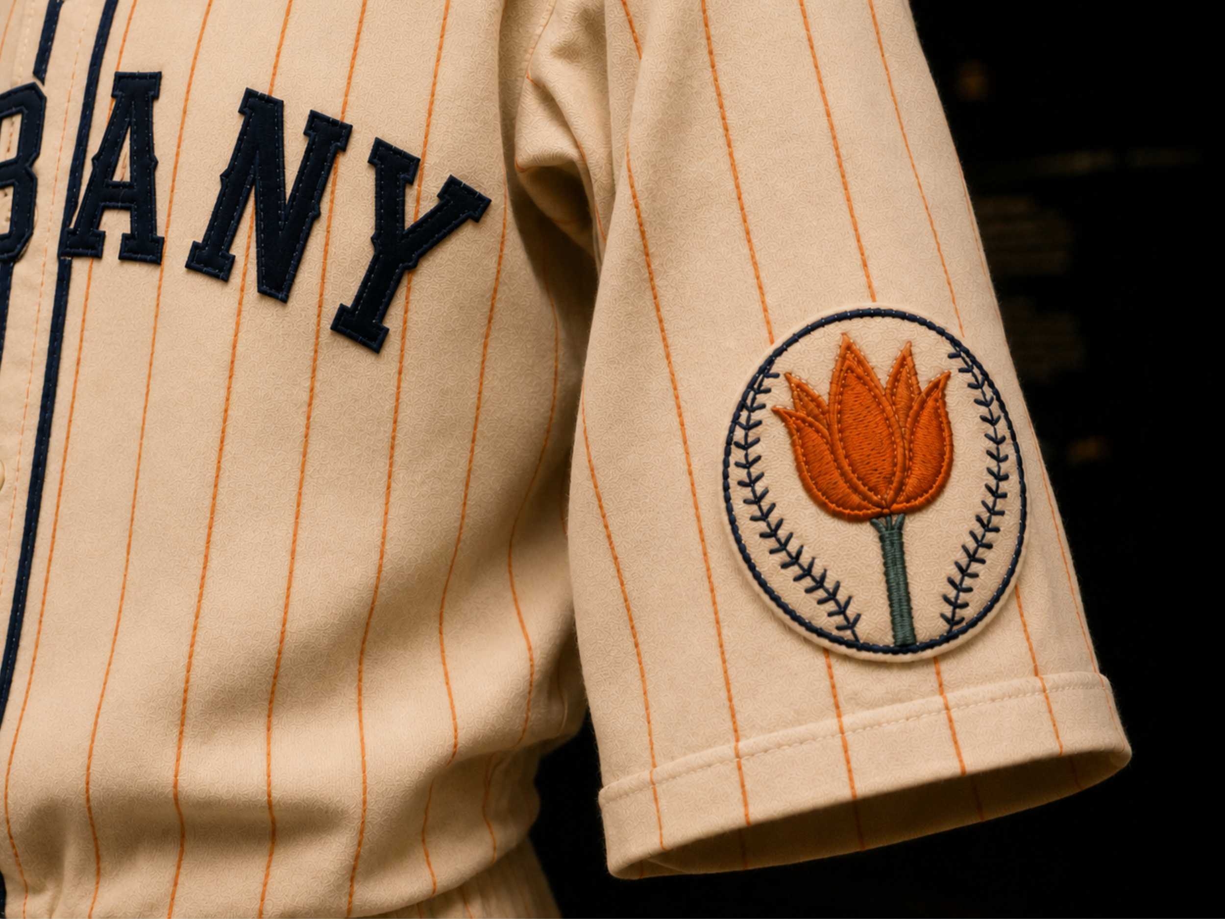 Close-up of Orange Wonder tulip patch on cream flannel sleeve.