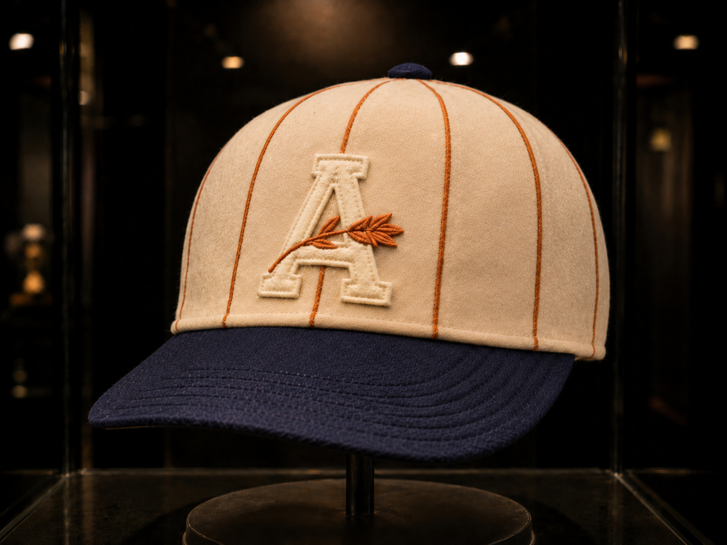 Albany Orange Wonders cream and navy cap with orange seam piping and cream A.