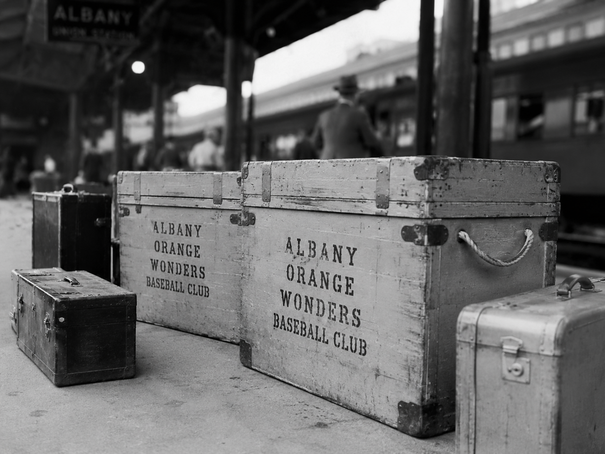 Albany Orange Wonders travel gear on train platform.