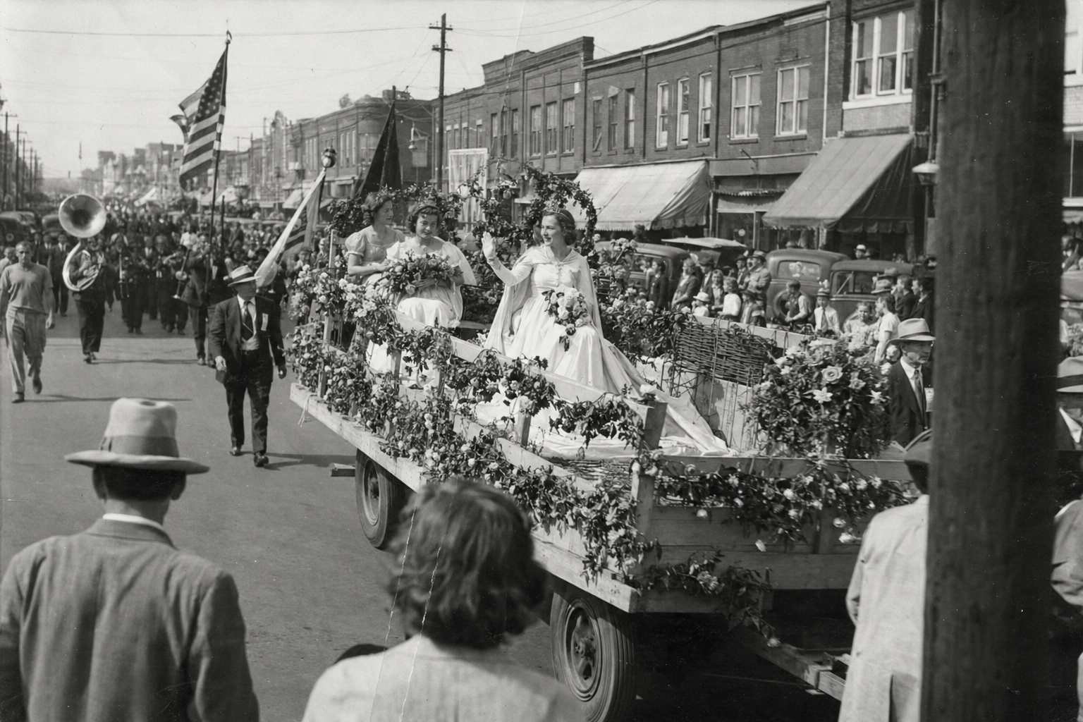 Rose Queen and court riding a flower-covered float through downtown Tyler in 1936.