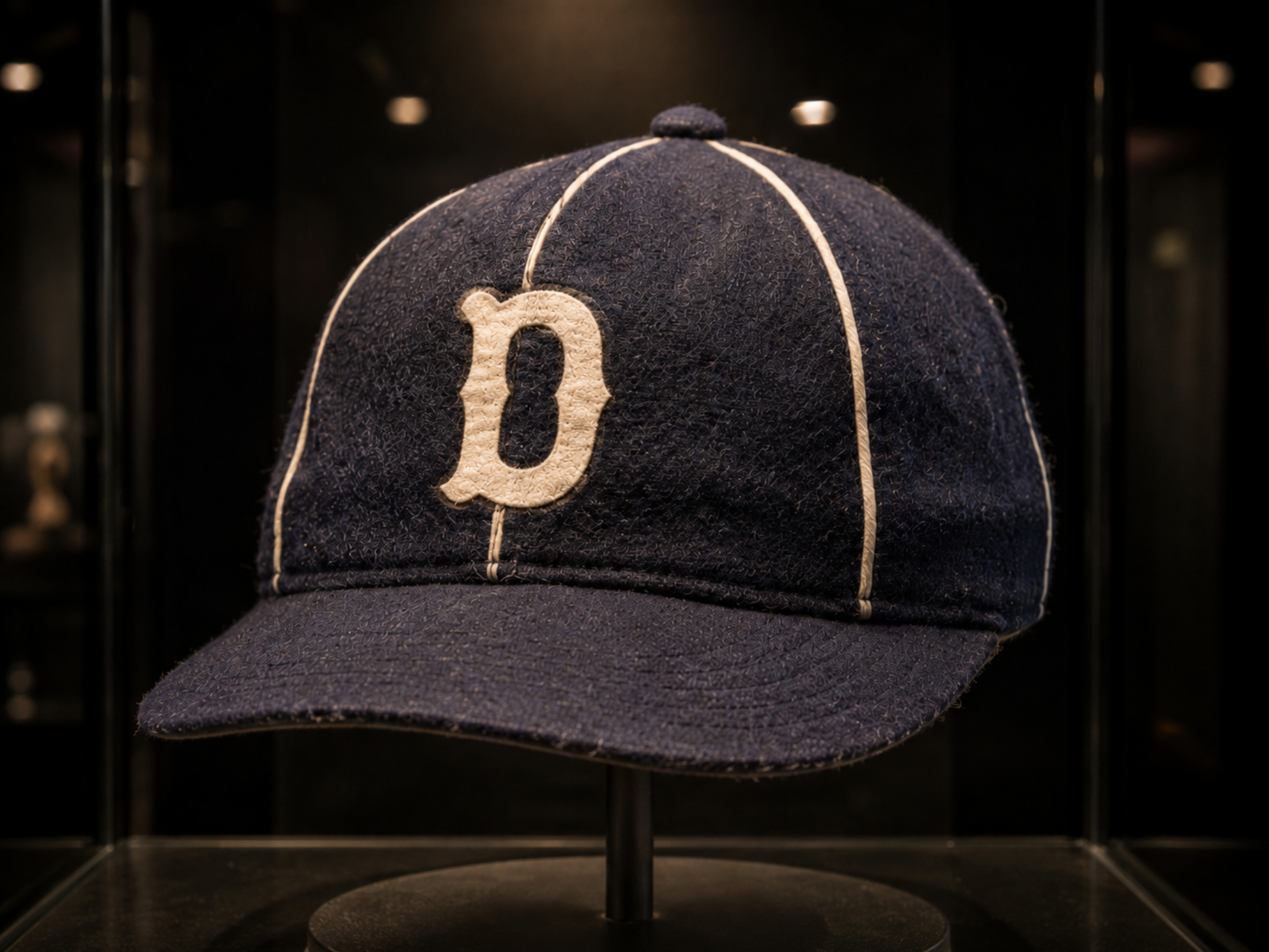 Navy Davenport Deadheaders baseball cap with cream seam piping and a cream block D on the front.