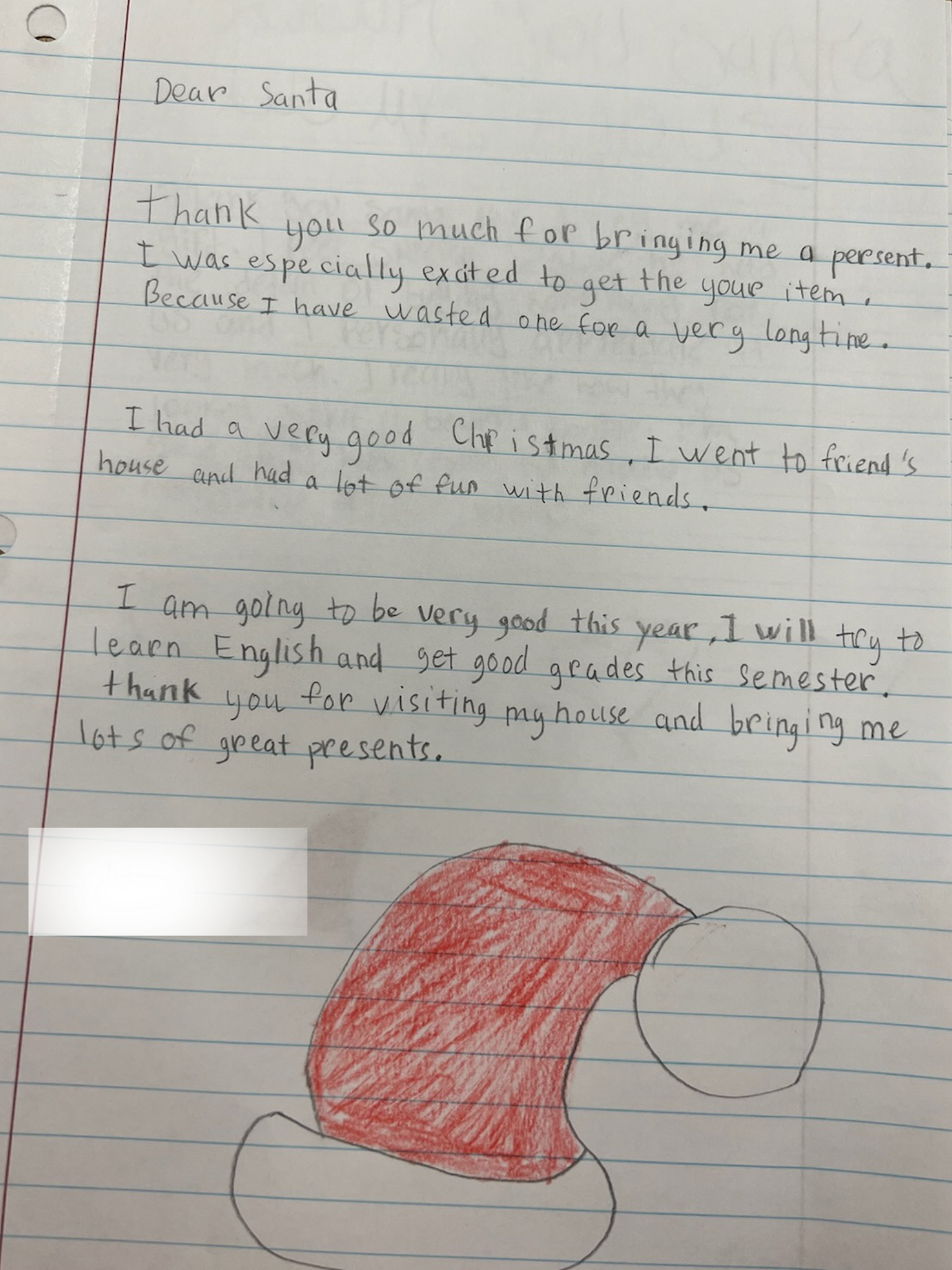 Handwritten letter on lined paper thanking Santa, with a drawing of a red and white Santa hat at the bottom.