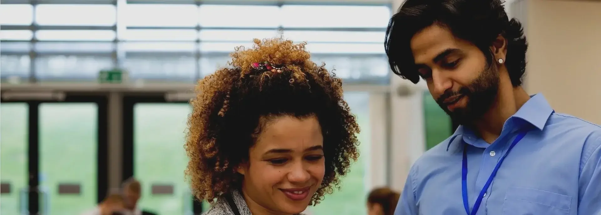 Male and female teachers smiling in school