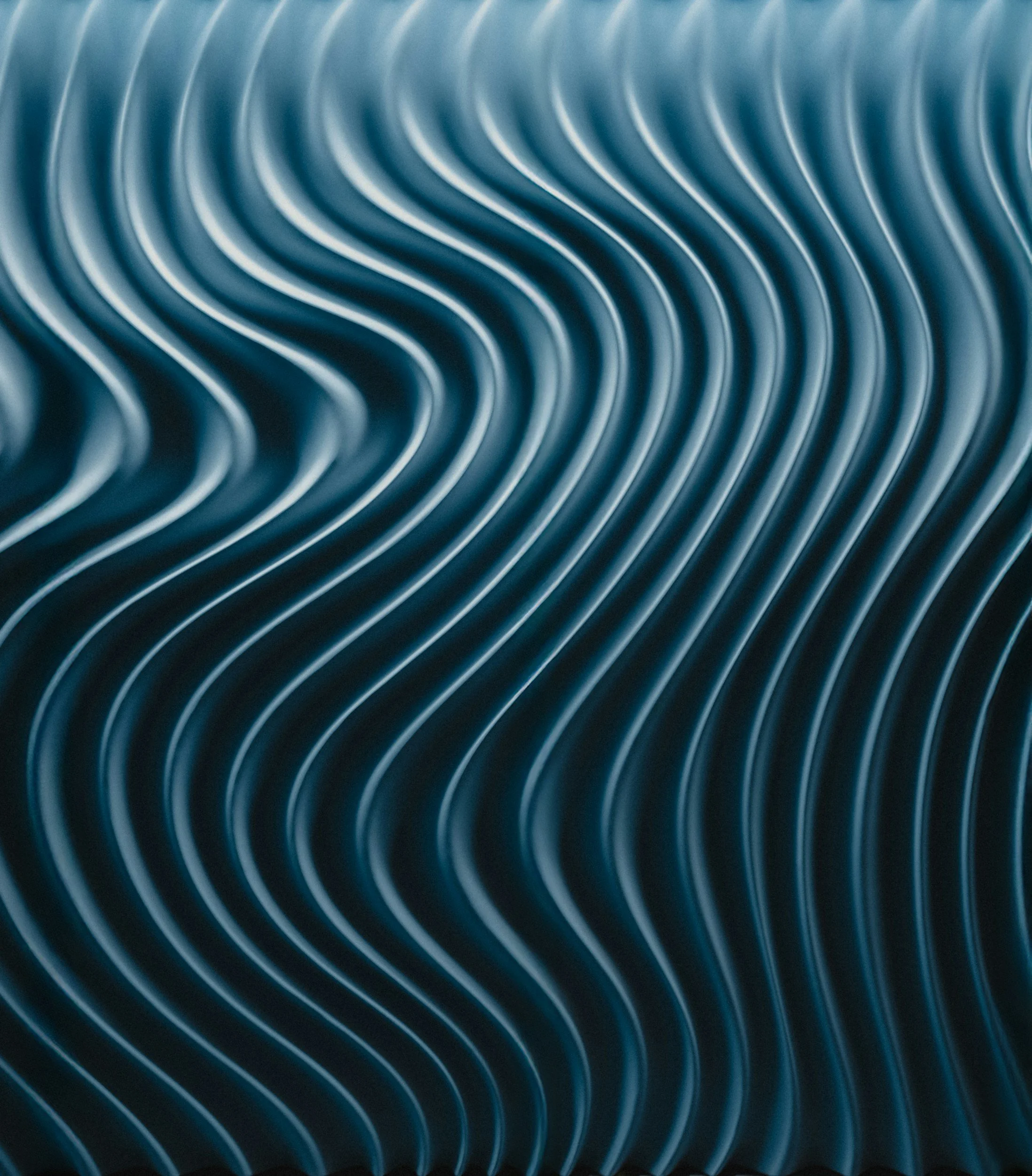 Close-up of symmetrical, wavy, metallic blue lines creating a tunnel-like pattern.