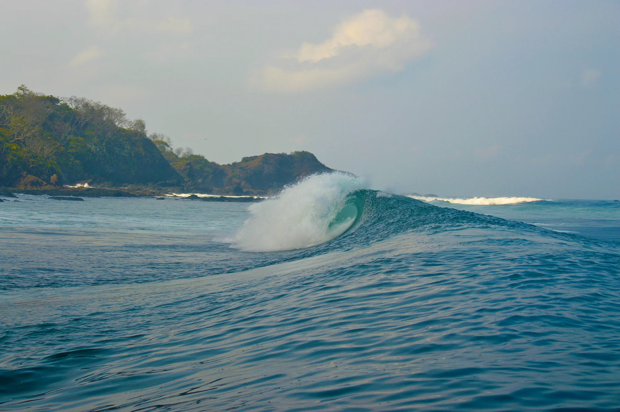An unridden left peels off a secret reef.