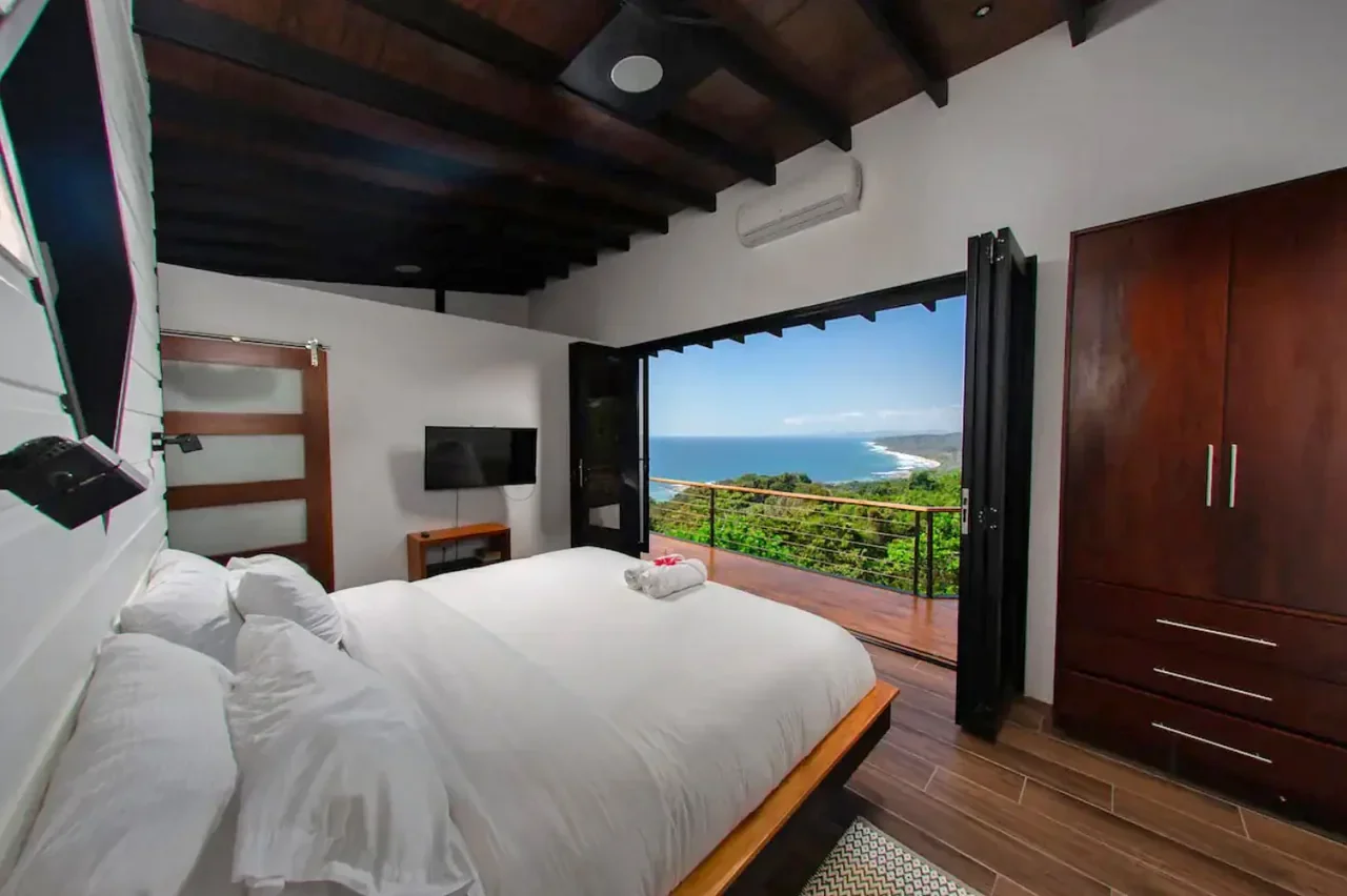 Bedroom with balcony and panoramic ocean view — Mal País, Costa Rica Airbnb vacation rental.