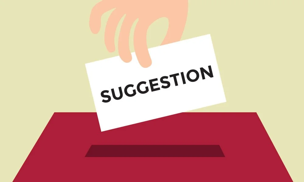 A hand holding a suggestion card above a red box or ballot box.