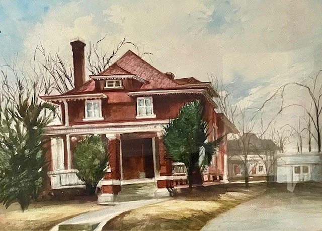 A large, old, two-story house with a porch, surrounded by trees and bushes, with a sidewalk and a street in front.