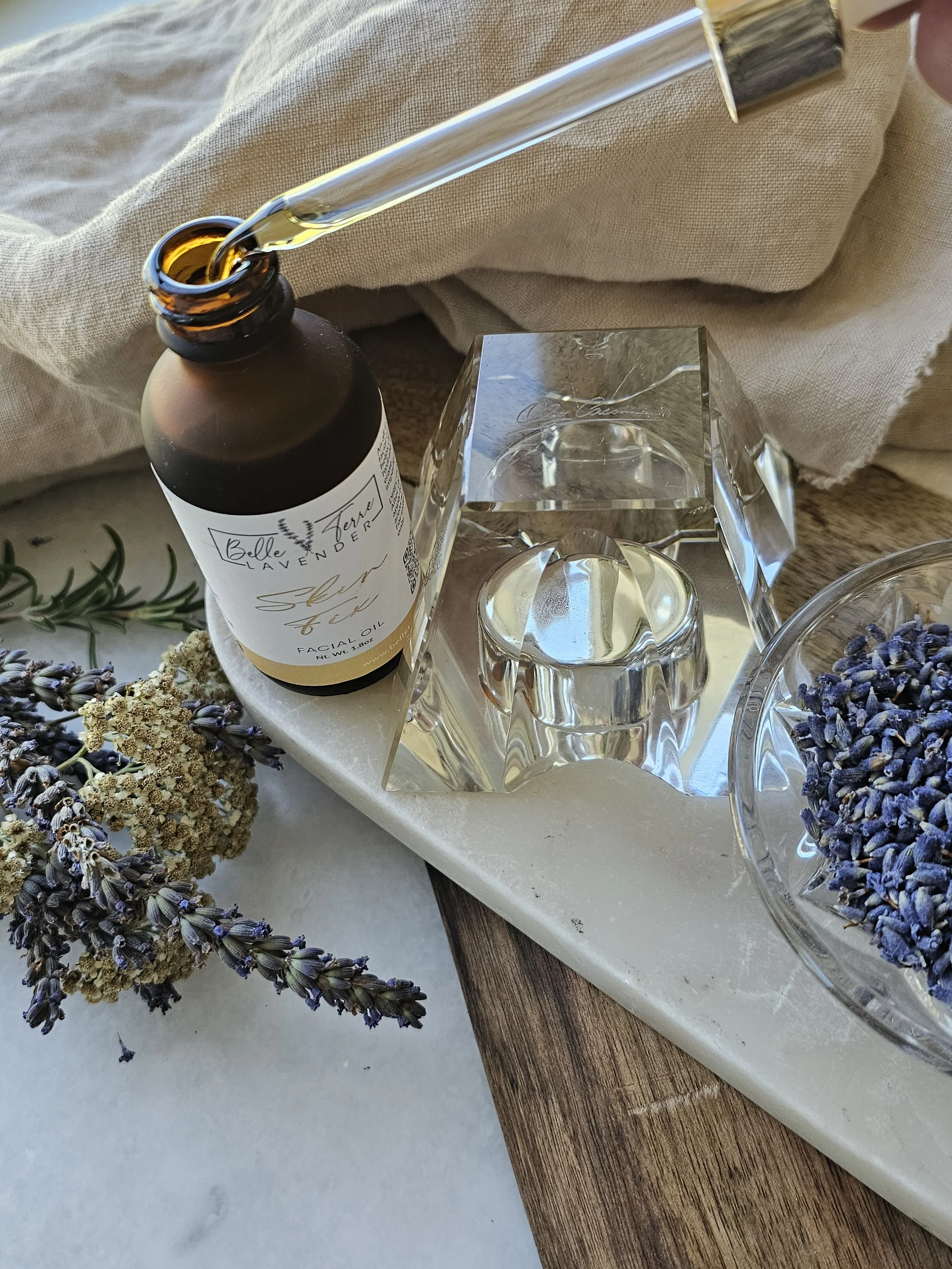 Belle Terre Lavender Skin Fix facial oil bottle with dried lavender on marble