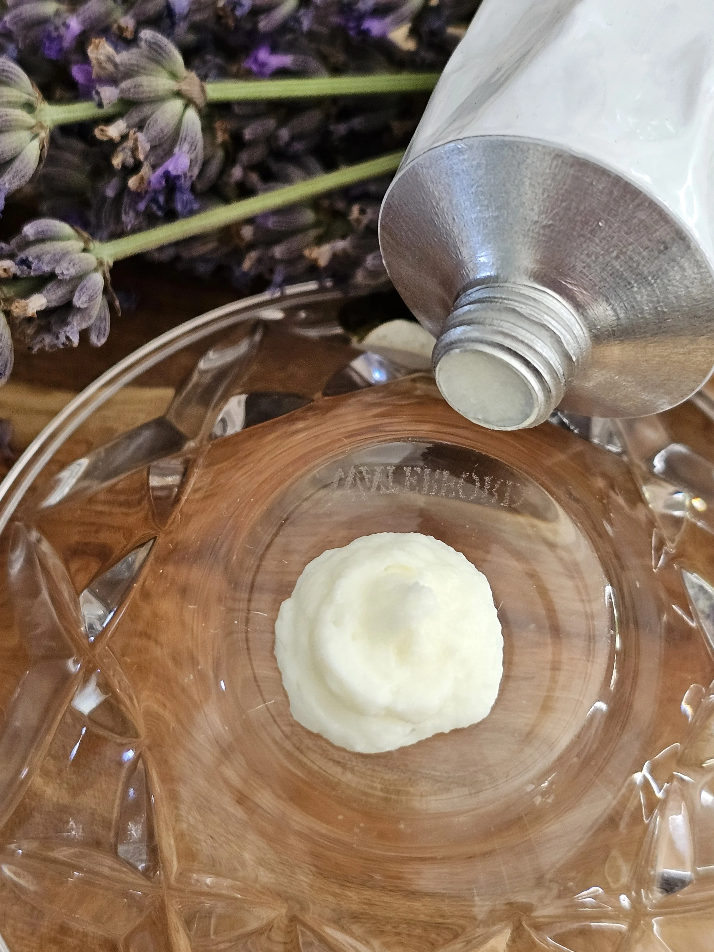 Belle Terre Lavender Body Cream squeezed onto glass dish
