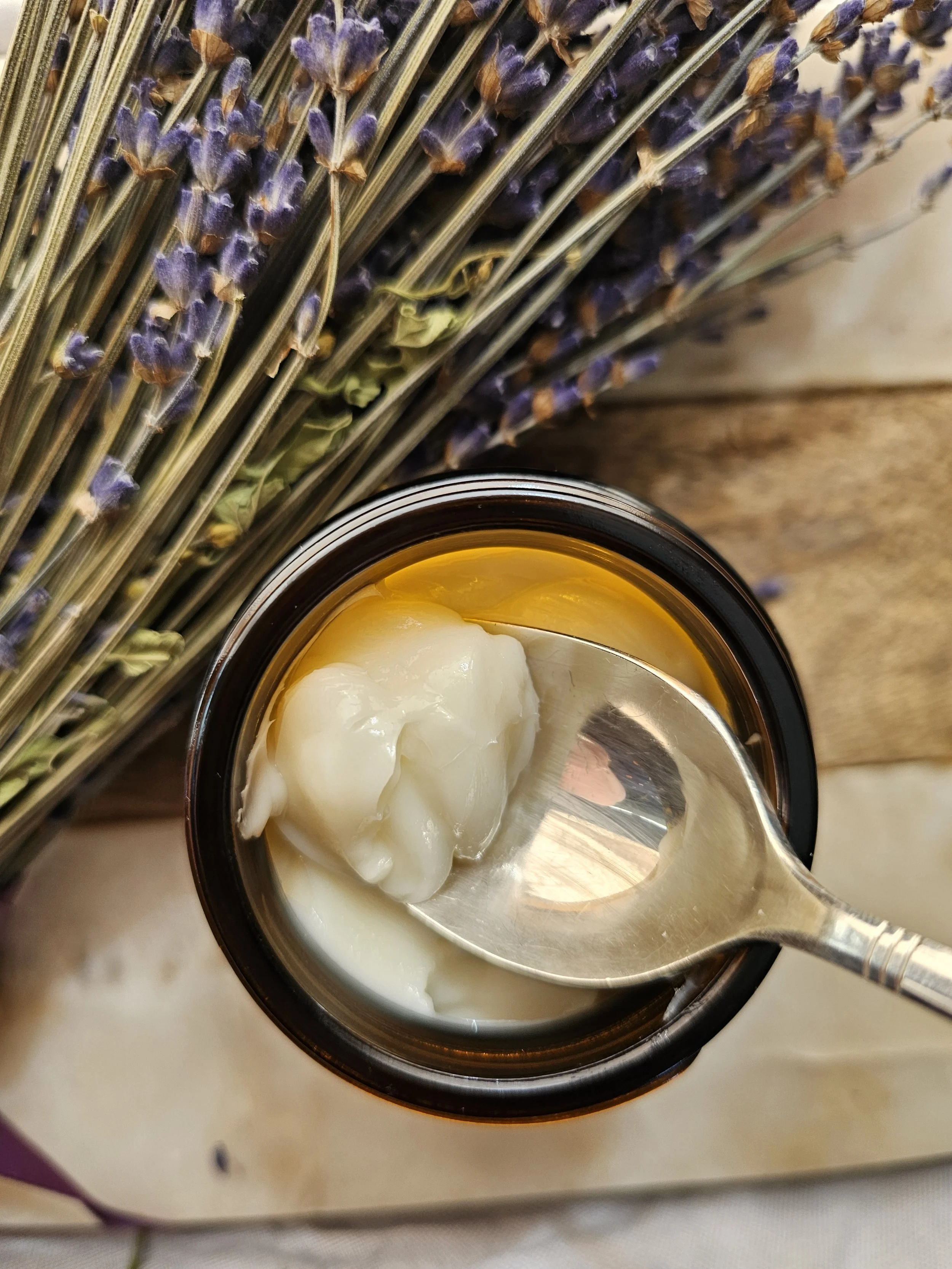 Belle Terre Lavender magnesium cream scooped from jar with lavender