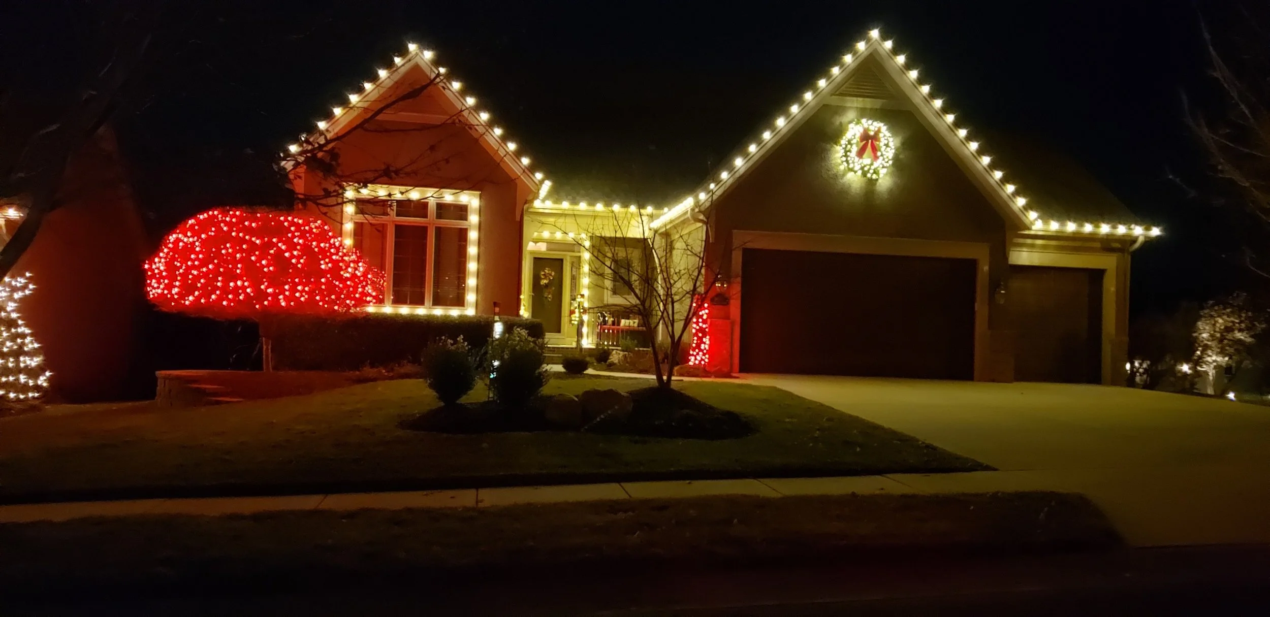 roofline with a red tree wrap, window lining, and a wreath