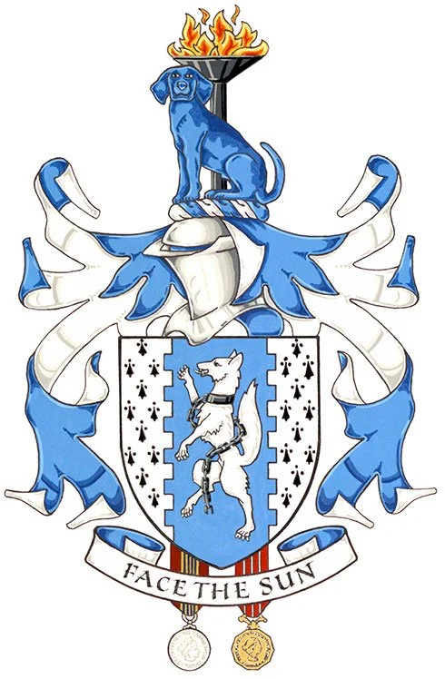 A family crest featuring a blue and white shield with a white dog standing on hind legs, wearing a collar, and surrounded by blue and white mantling. Above the shield, a blue dog sitting on a black pedestal with fire above it. Beneath the shield, a ribbon with the motto 'Facethe Sun' and two medals hanging below.
