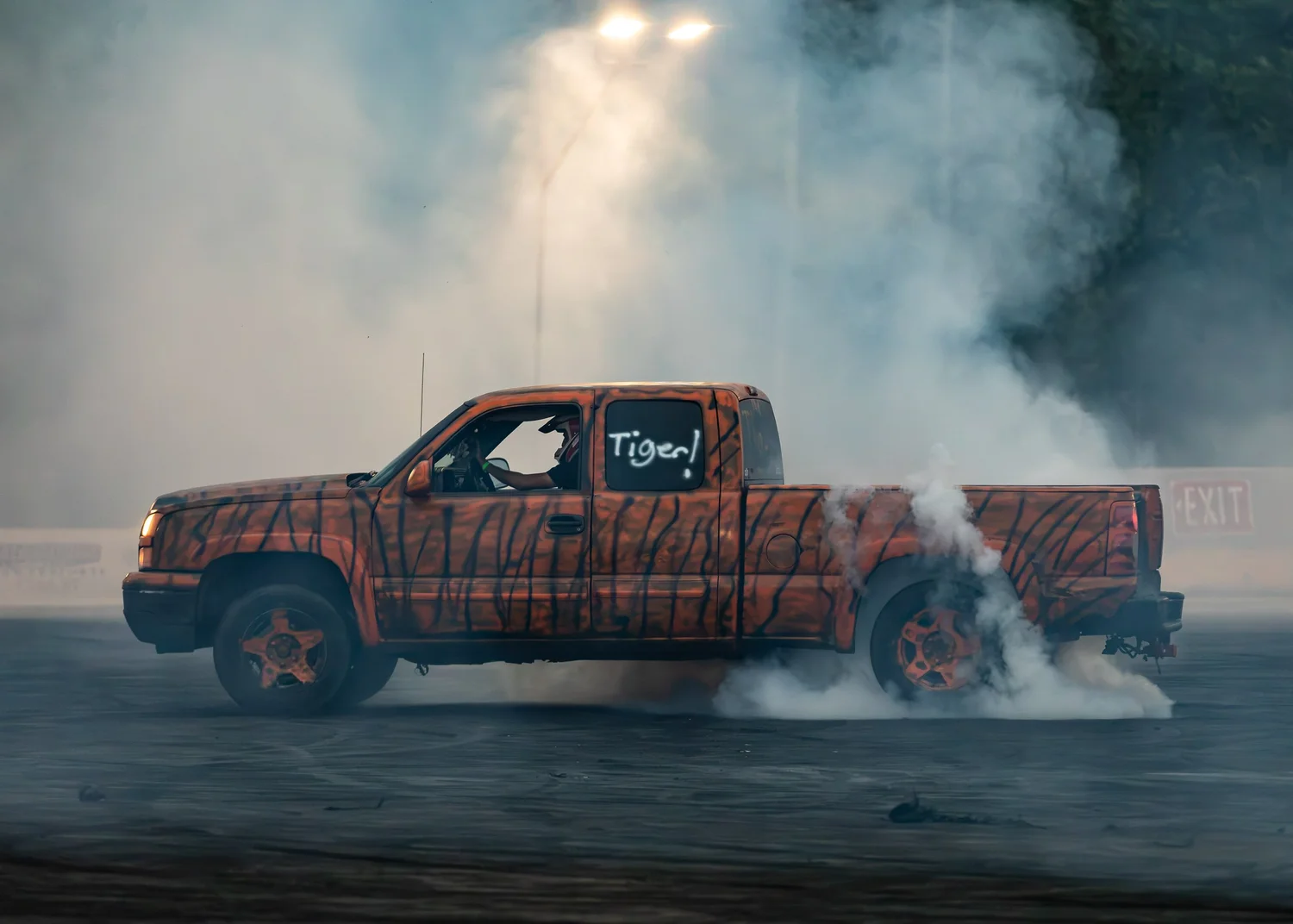 Tiger-striped pickup truck performing a smoky burnout at Big Indian Drift Pit.
