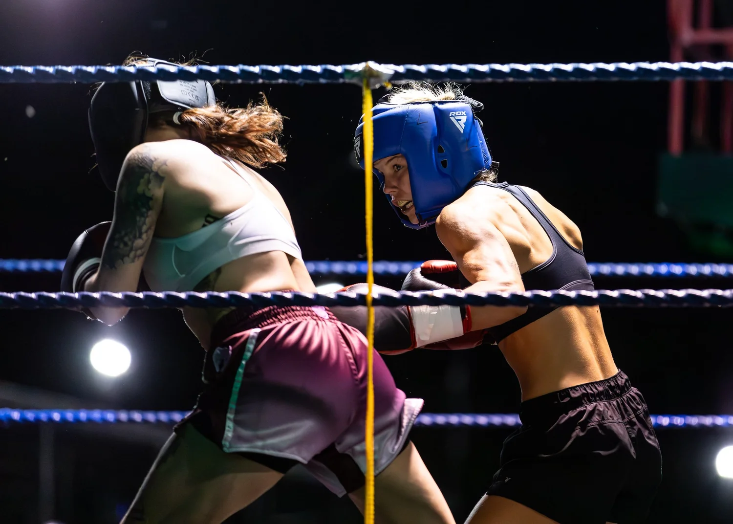 Taylah Robertson sparring in protective headgear and boxing gloves.