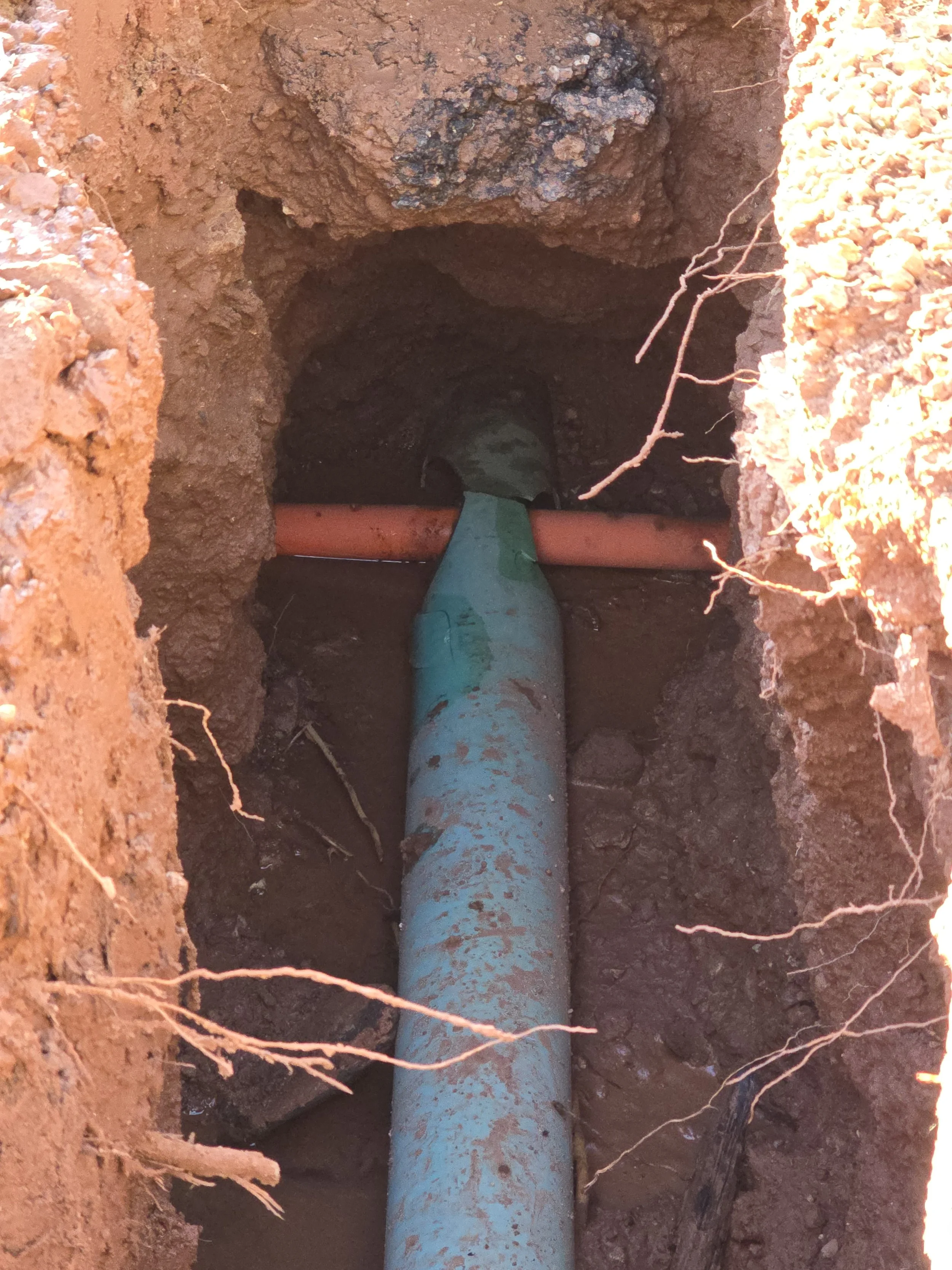 After a sewer inspection revealed an odd orange blockage in the pipe we excavated to find a communications cable had been bored directly through the sewer lateral.