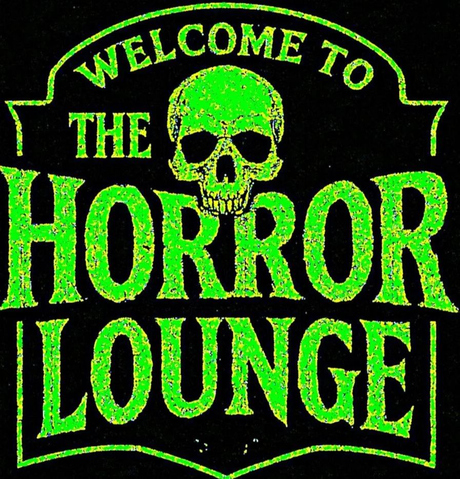 A neon green sign with the words "Welcome to the Horror Lounge" and a skull graphic, set against a black background.