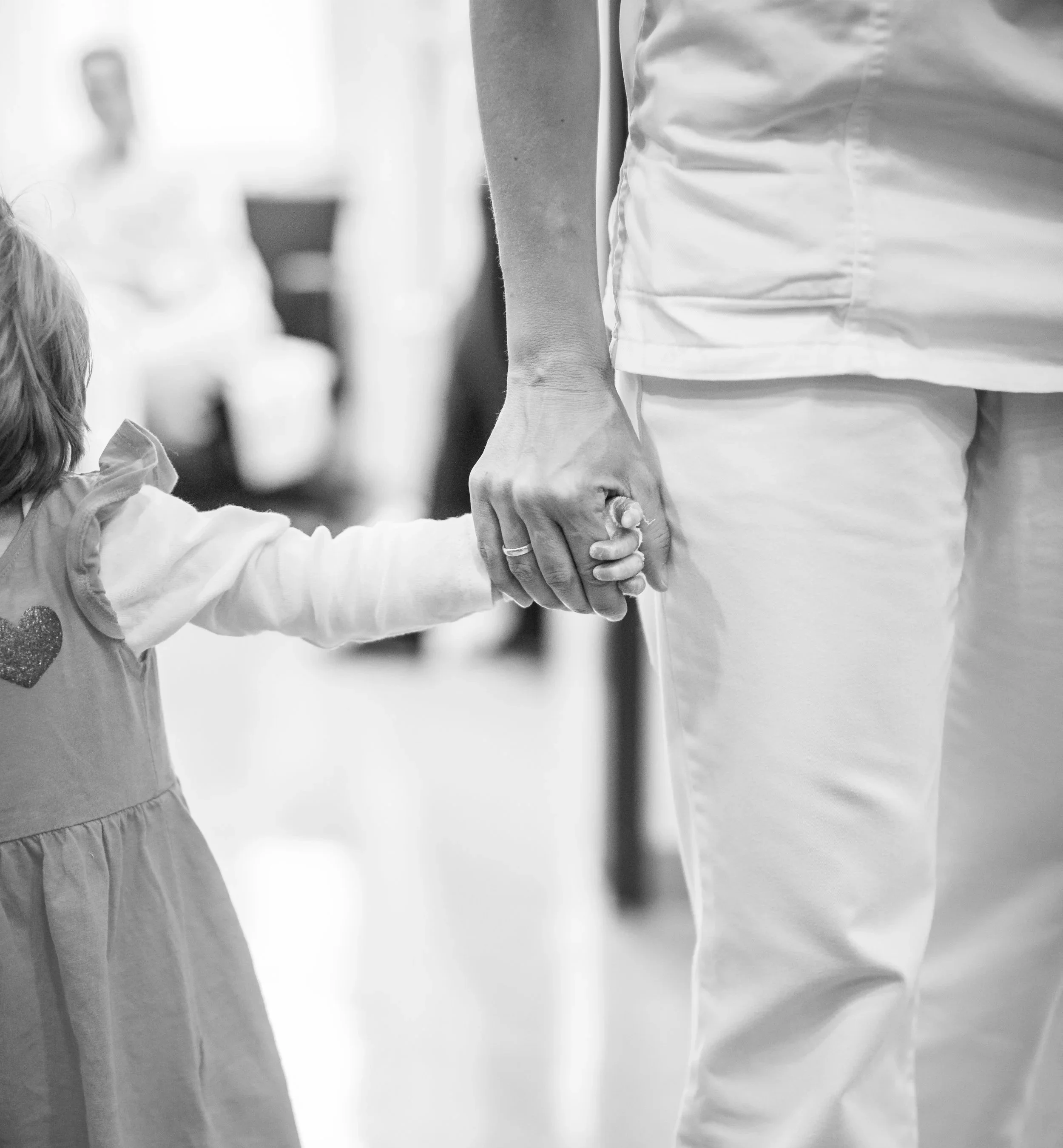 Child with EB wrapped hand holding hands