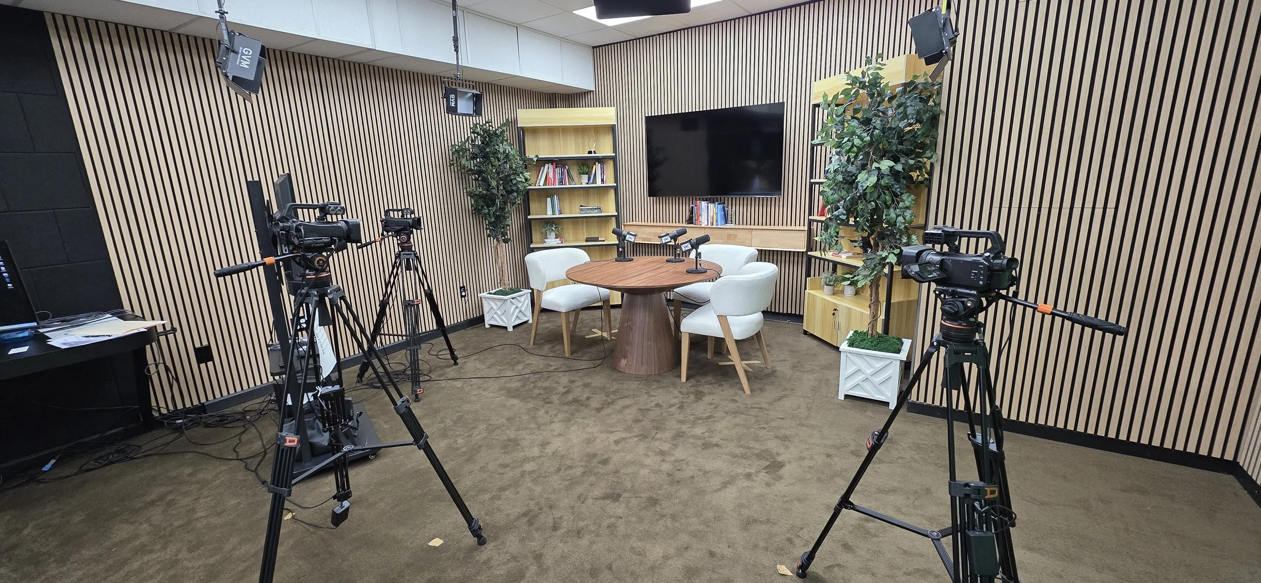 City Built recording studio with cameras, microphones, and guest chairs ready for a conversation