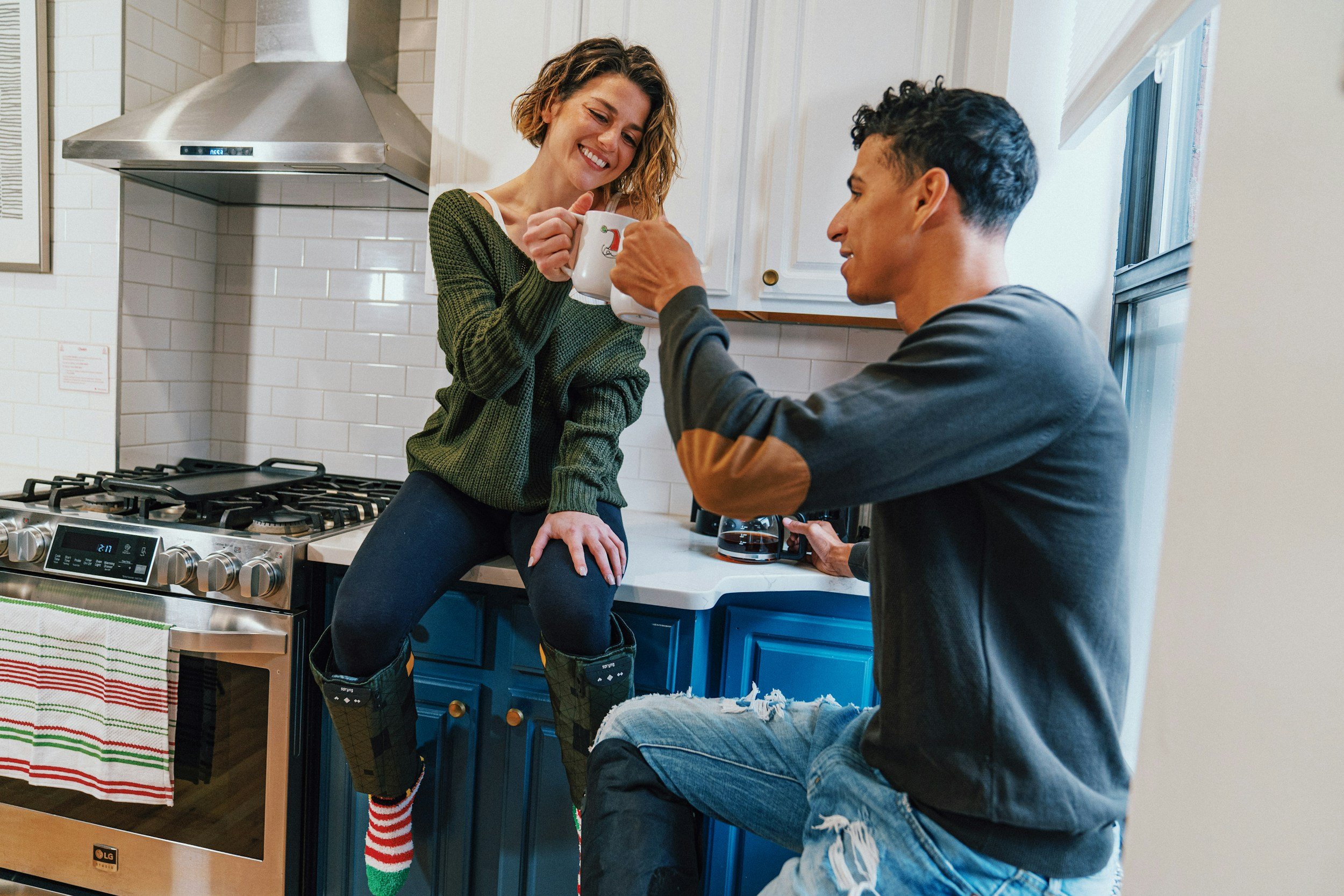 Smiling homeowners enjoying a clean kitchen after professional residential cleaning by RiverTown Cleaning Services, representing more time for family and less time spent cleaning.