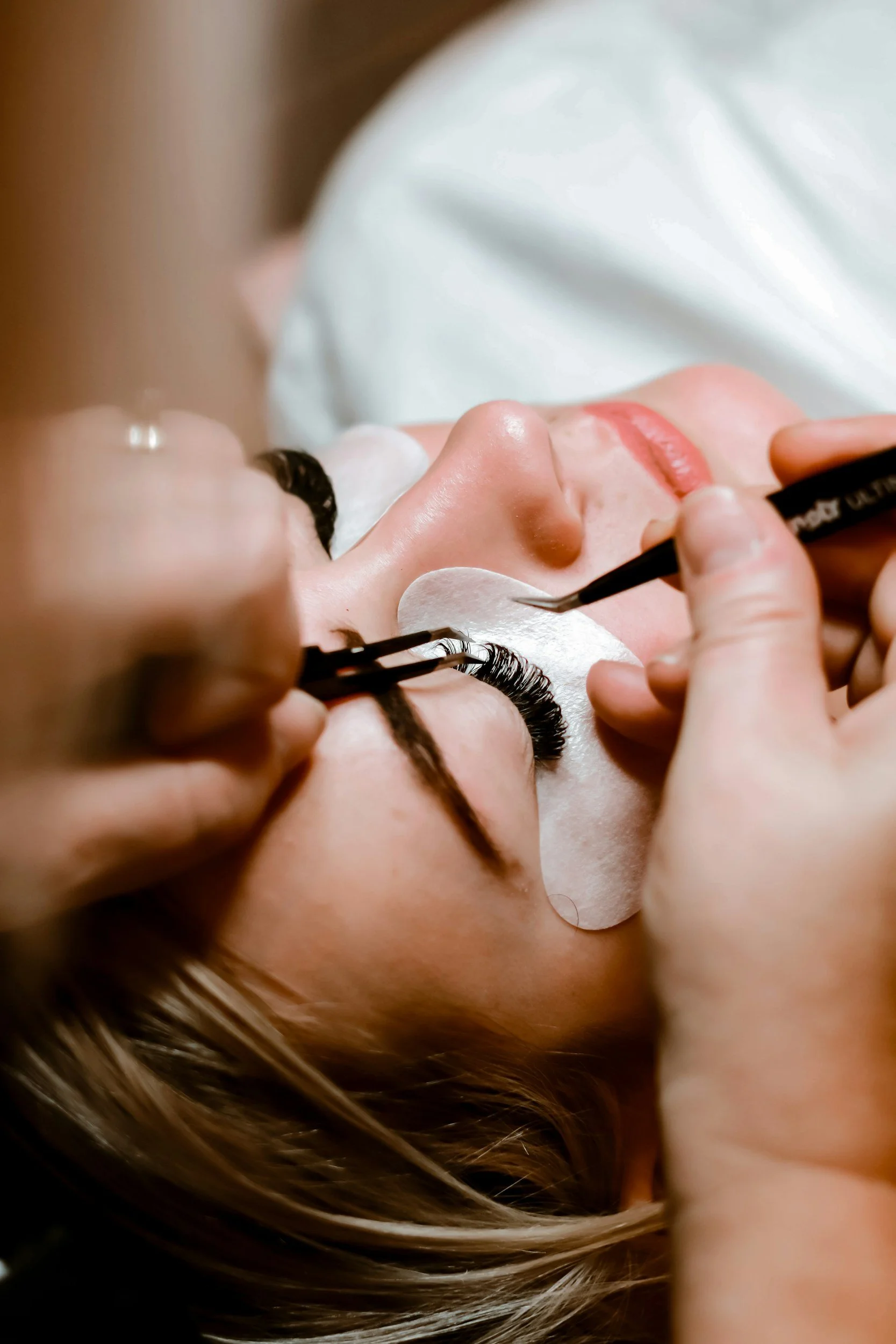 Close-up of a woman receiving eyelash extensions