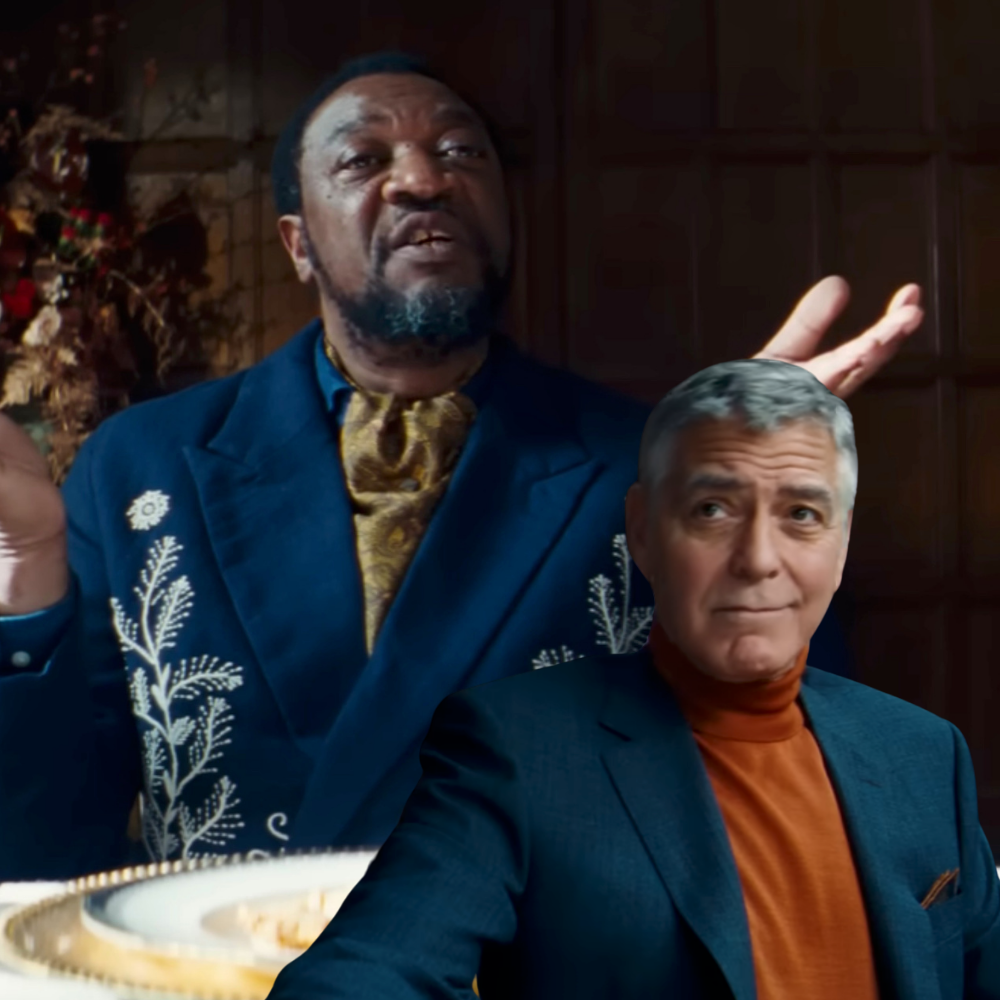 Two men in suits, one standing behind the other, with a woman’s hand gesturing in the background and a Christmas tree to the side.