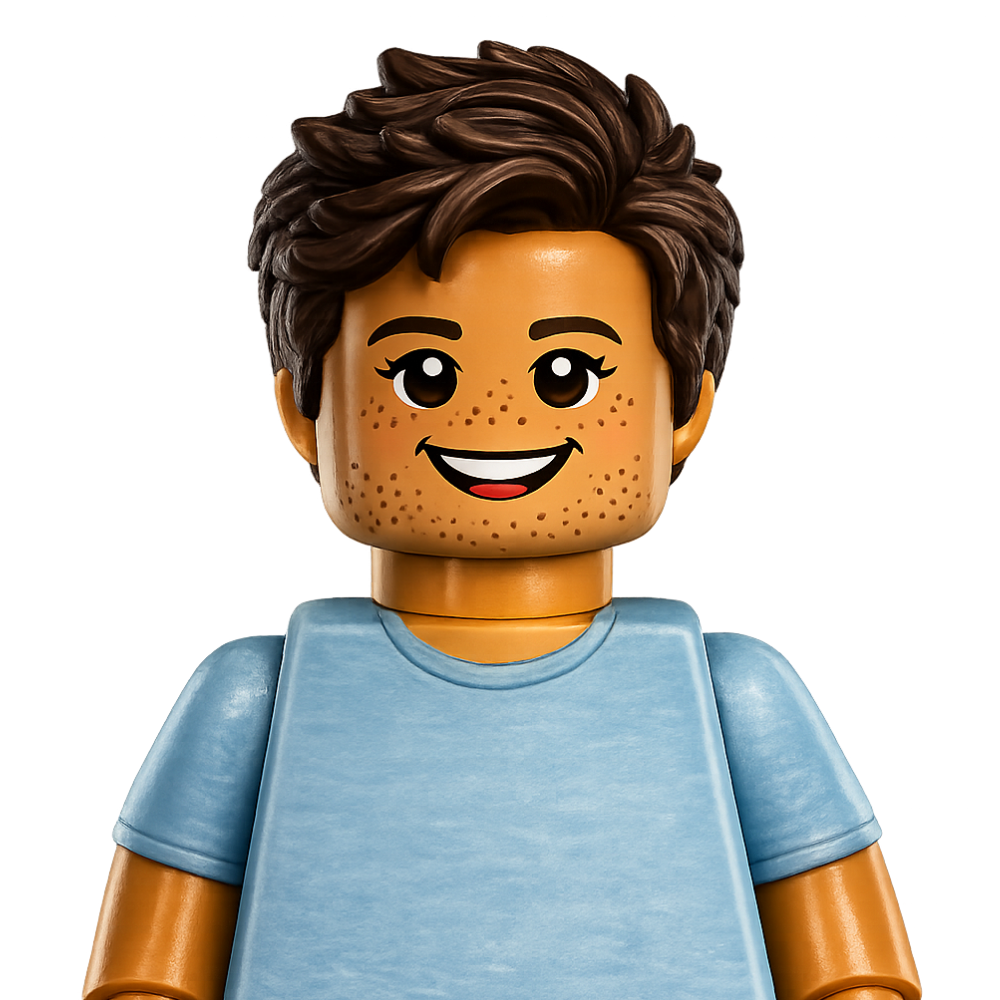 LEGO minifigure with dark hair, smiling face with freckles, wearing a light blue shirt.