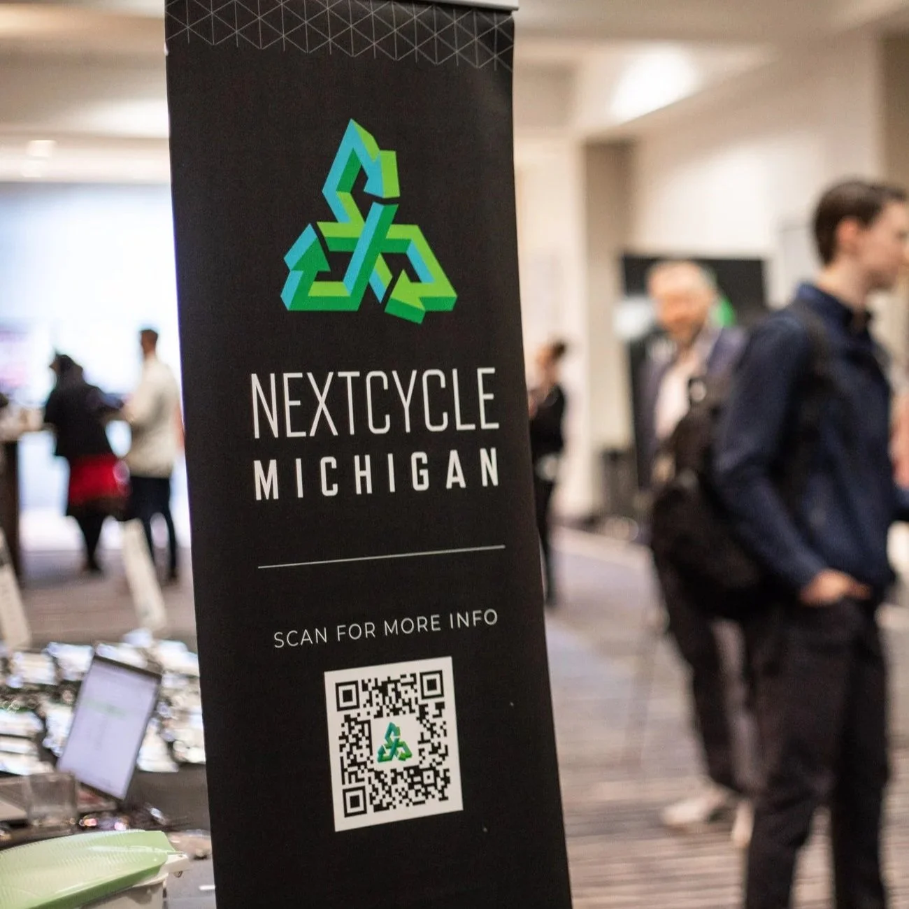 NextCycle Michigan vertical pop-up banner at a conference chall.