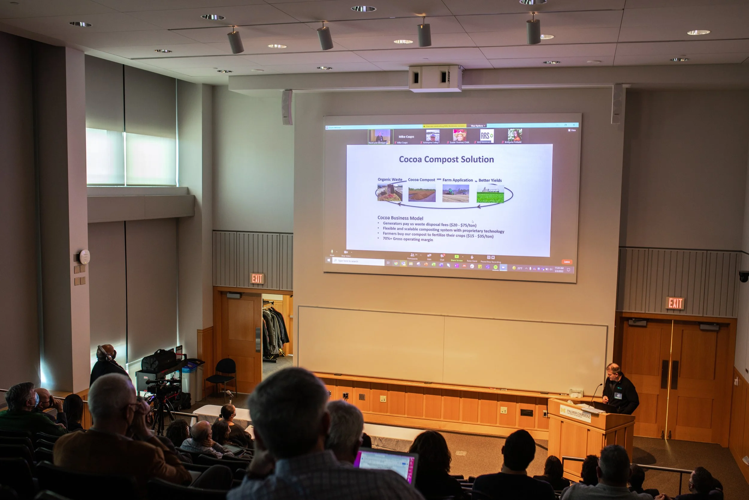 Auditorium filled with people listening to presentation