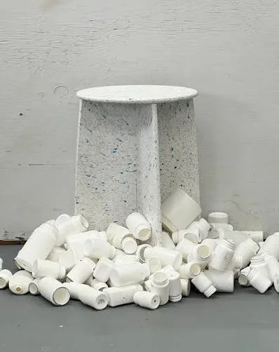 Plastic stool with multiple small plastic  pieces on the ground