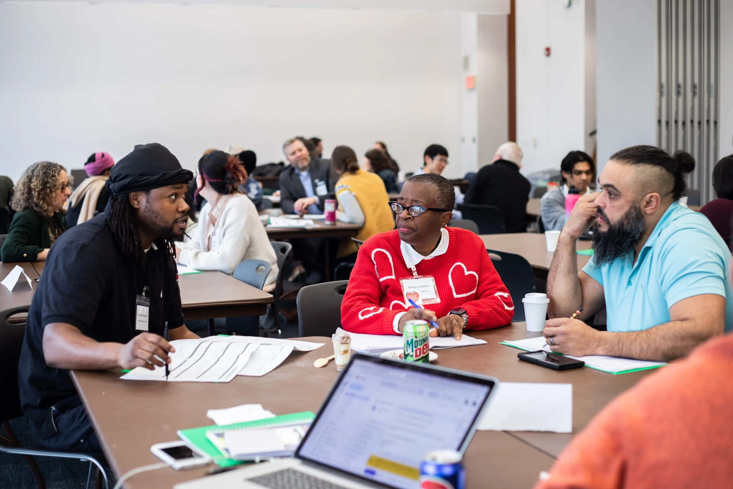 A group of people at a table having a conversation.