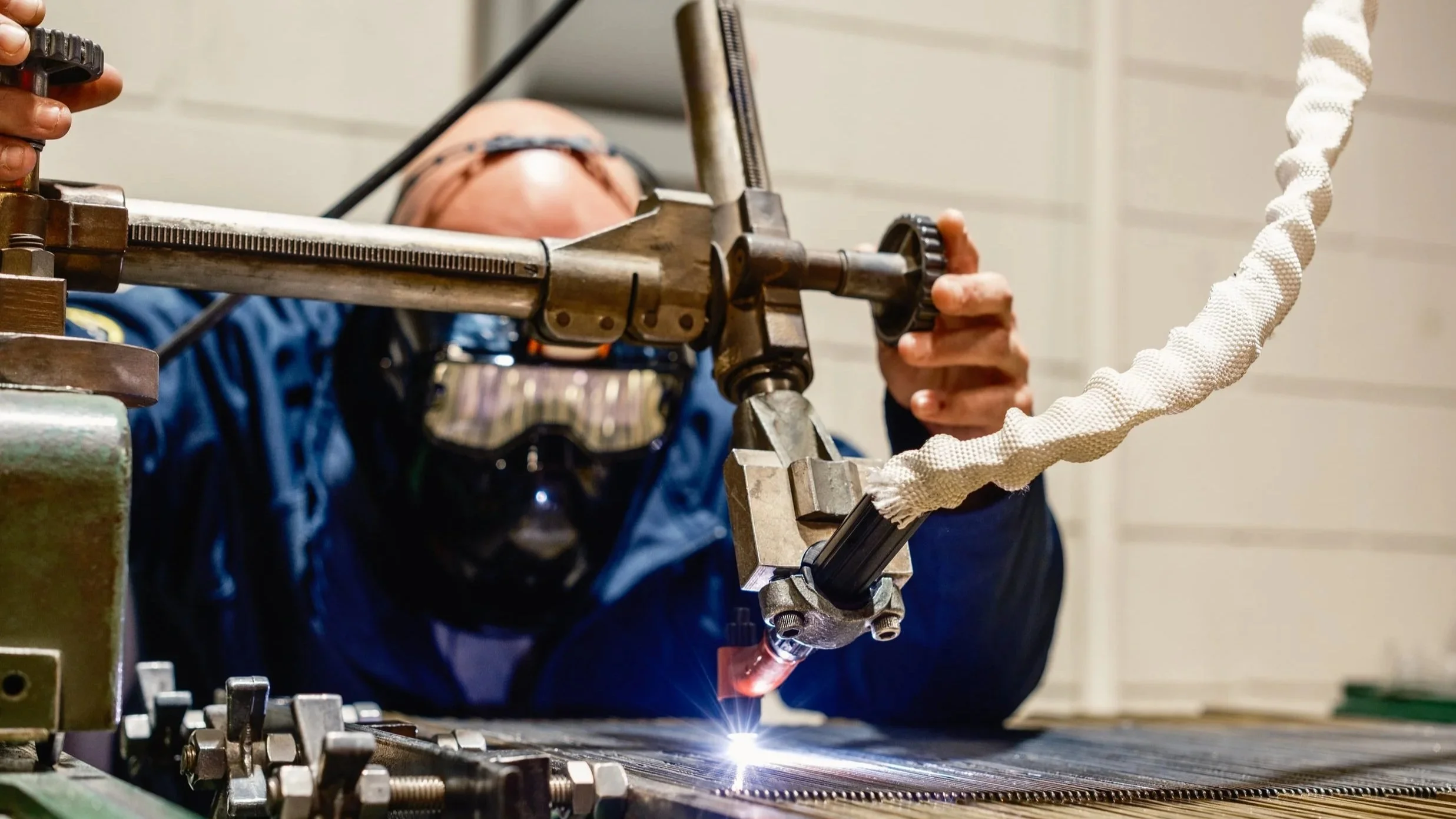CEPEDA employee performing precision welding in an industrial manufacturing facility