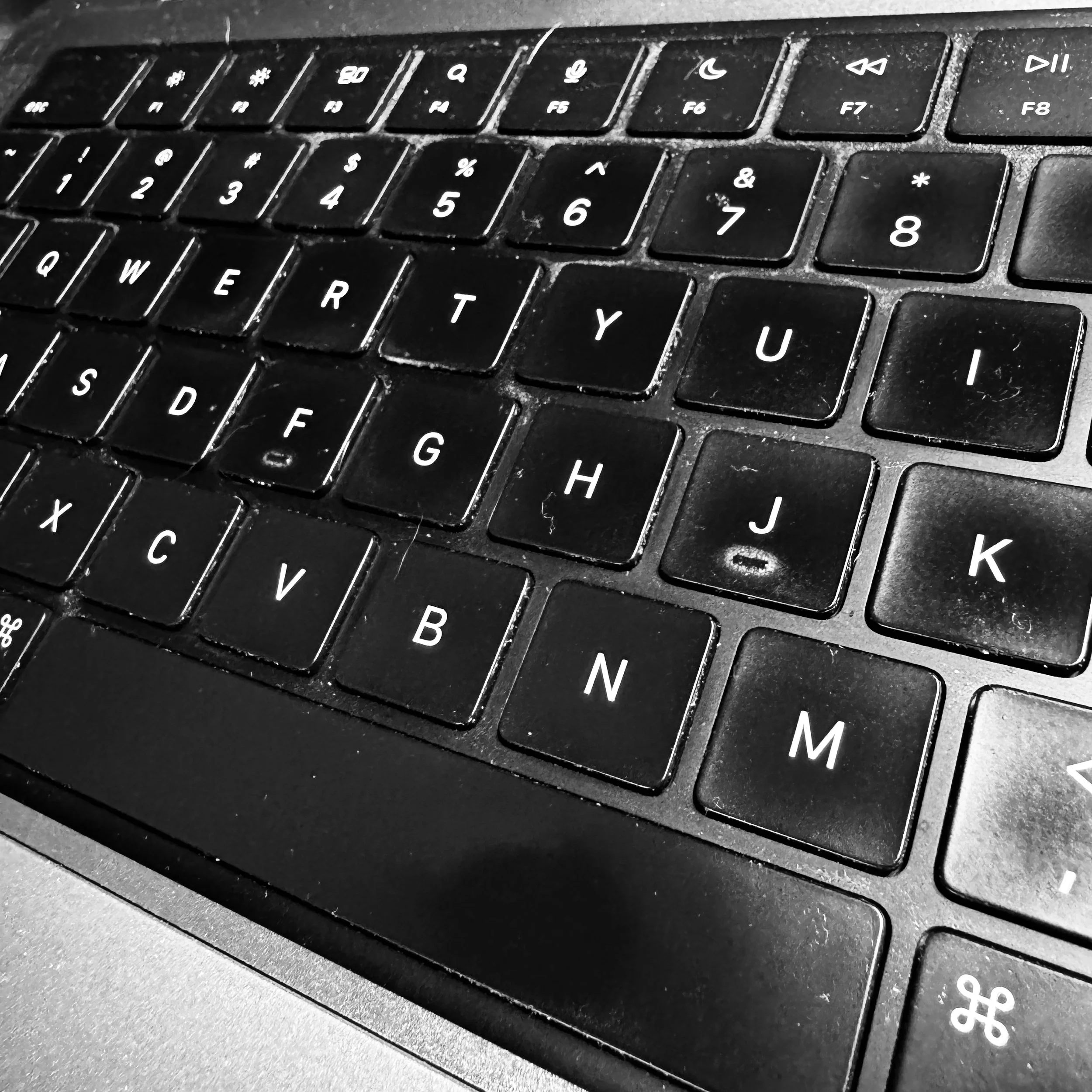 black and white image of a laptop keyboard