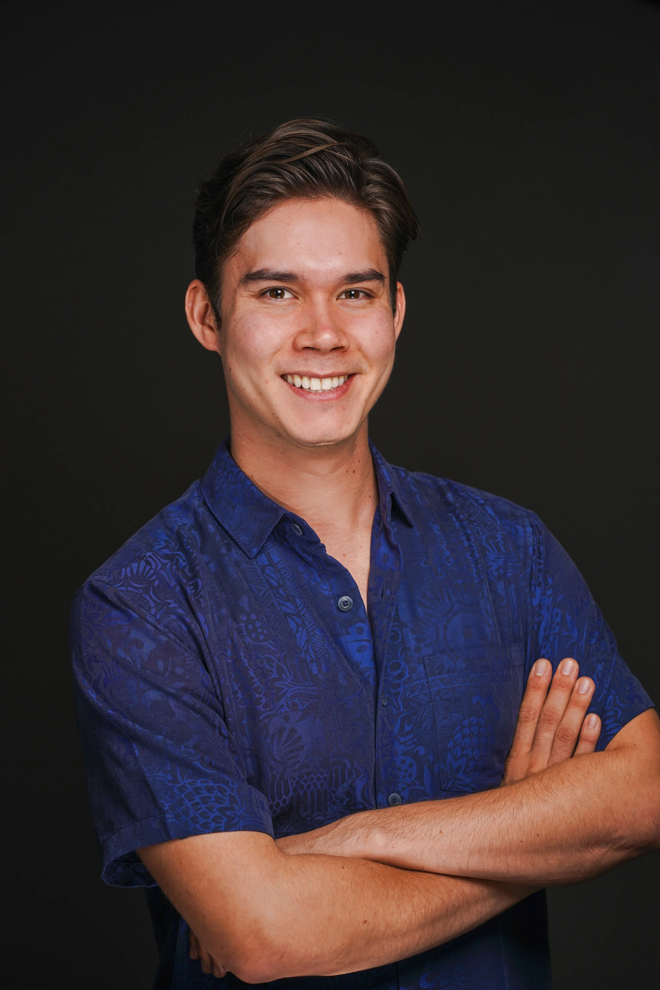 Portrait of David Pierce smiling with his arms crossed.