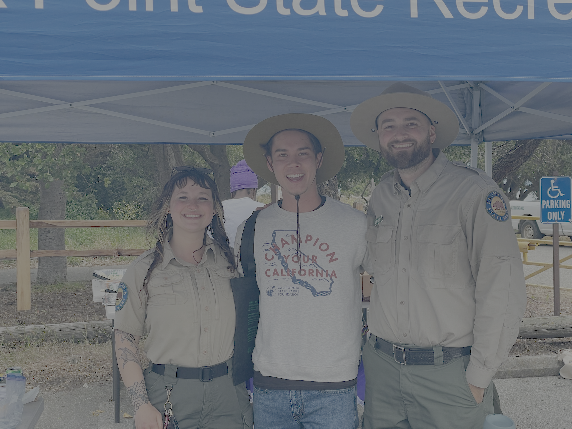 David Pierce poses with California State Parks staff at an outdoor California State Parks Foundation event.
