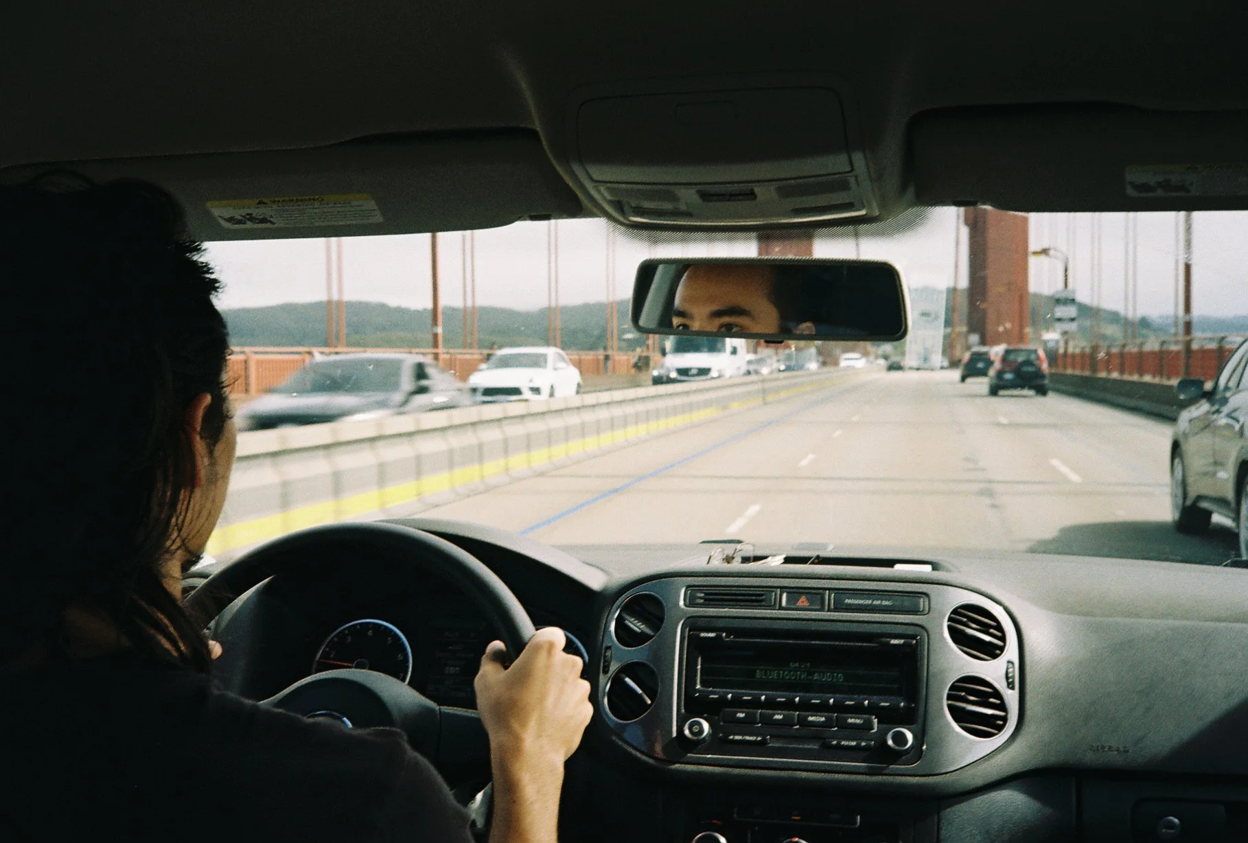 David Pierce reflected in the rearview mirror while driving across the Golden Gate Bridge in San Francisco.