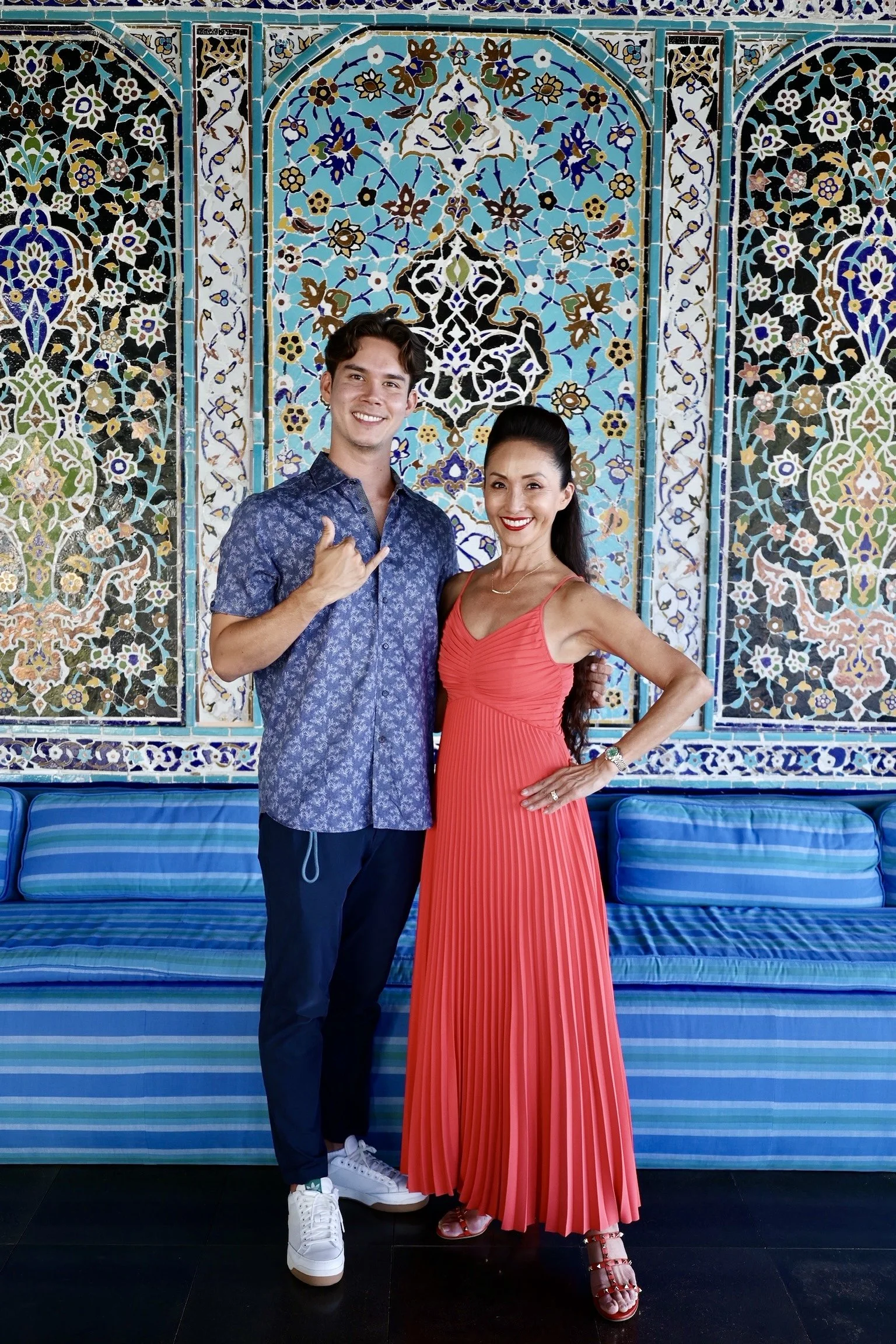 David Pierce poses with his mother in front of a colorful mosaic at Shangri La Museum of Islamic Art, Culture & Design.