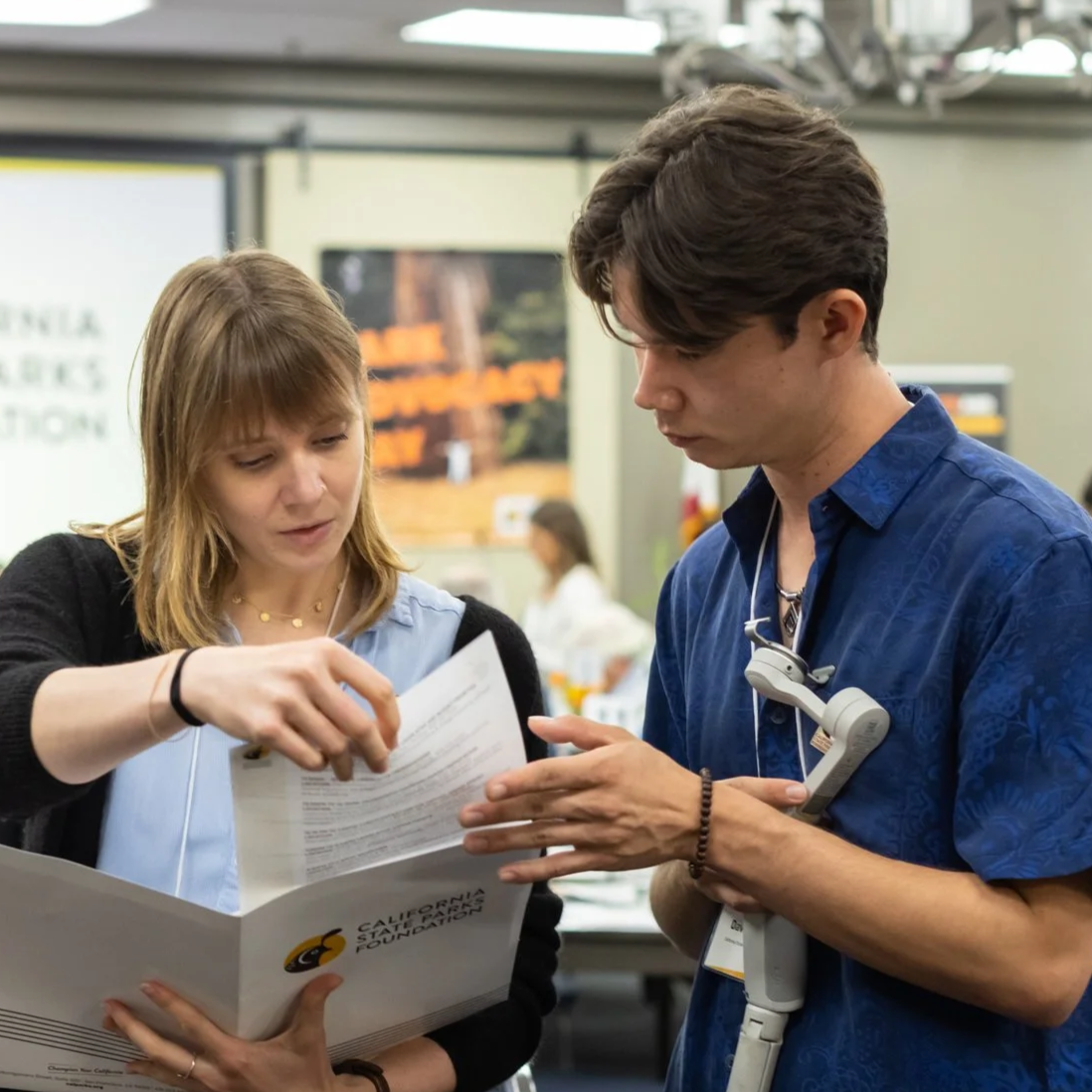 David Pierce reviews California State Parks Foundation materials with a colleague at an event in Sacramento.