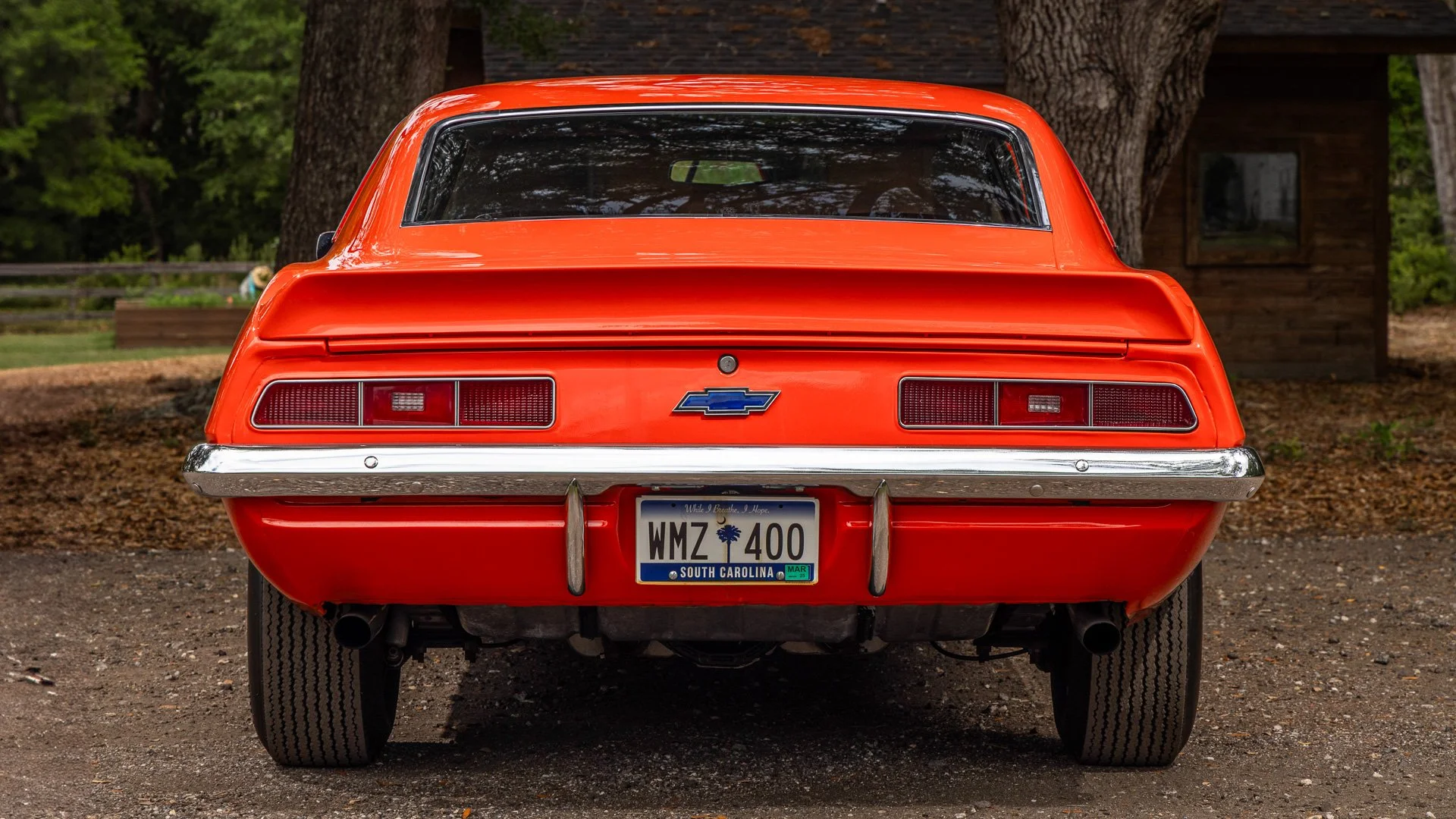 Rear view of a bright red vintage Chevrolet car parked outdoors with a South Carolina license plate reading 'WMZ 400'.