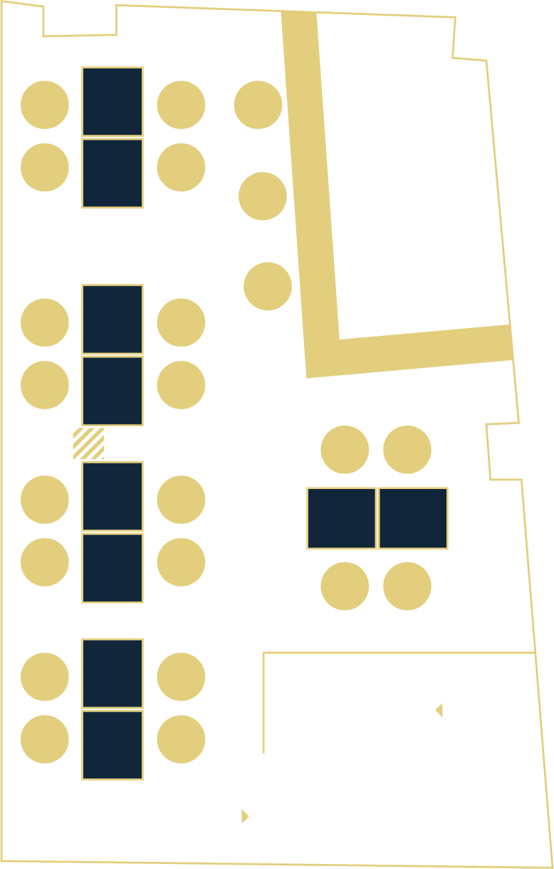 Floor plan of a building with various rooms, tables, and seating areas outlined.