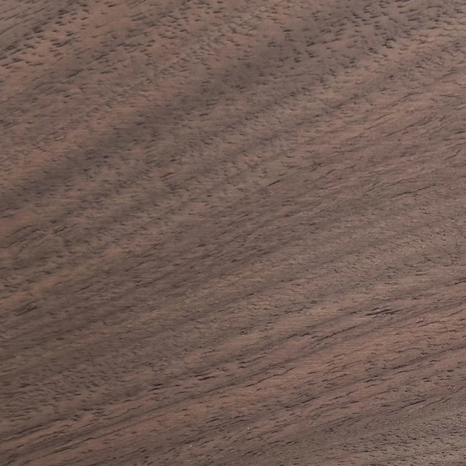 Close-up of a brown wooden surface with visible grain texture.