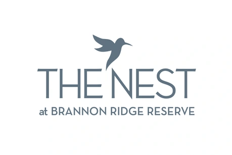 Logo for The Nest at Brannon Ridge Reserve featuring a stylized hummingbird.