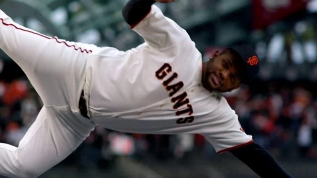A baseball player from the San Francisco Giants sliding into a base during a game.