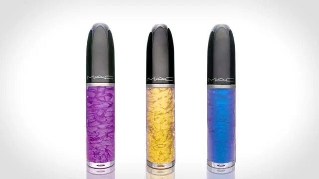 Three MAC lipsticks in purple, yellow, and blue shades against a white background.