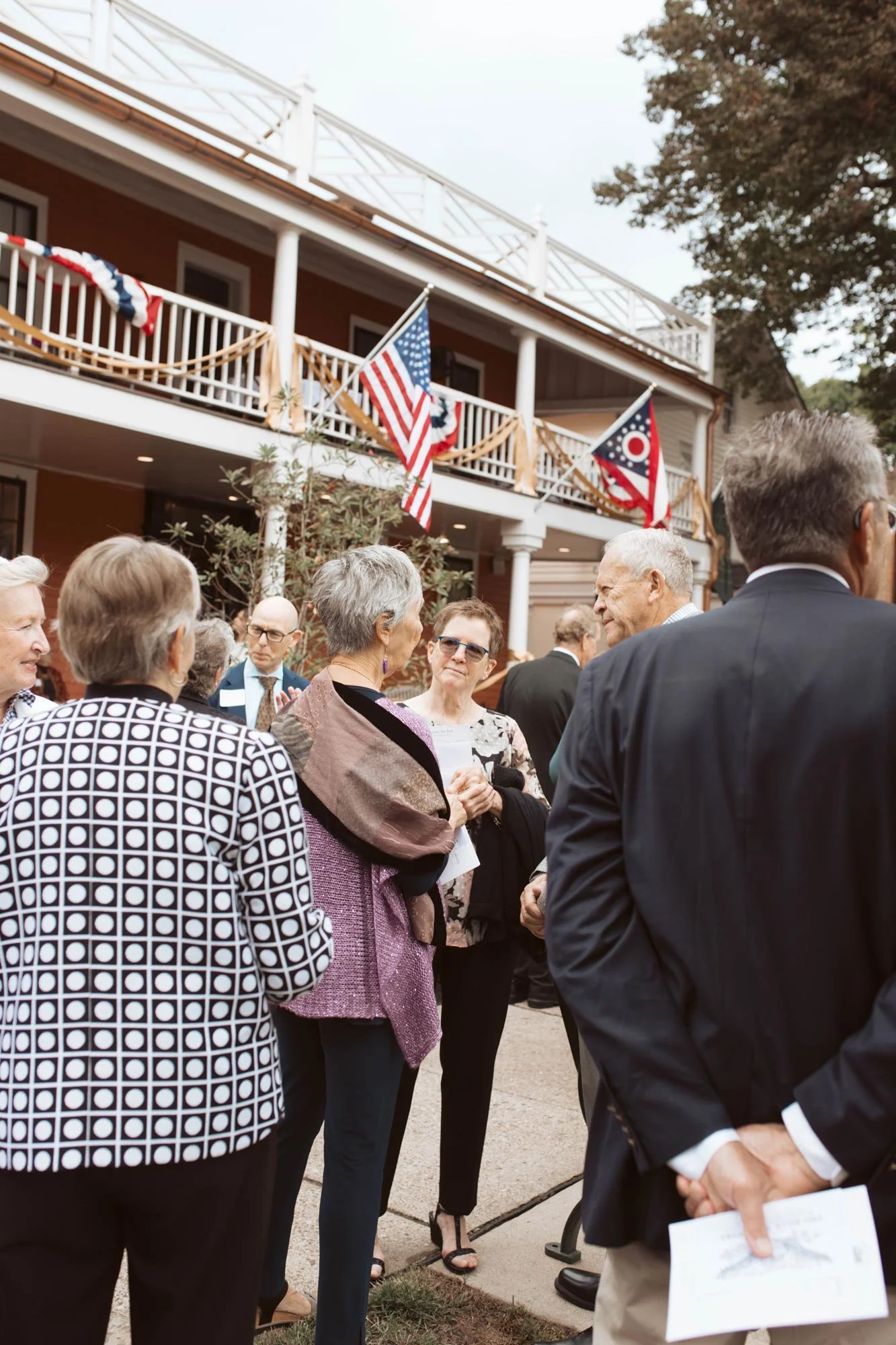A conversation among guests beside the inn's front porch.